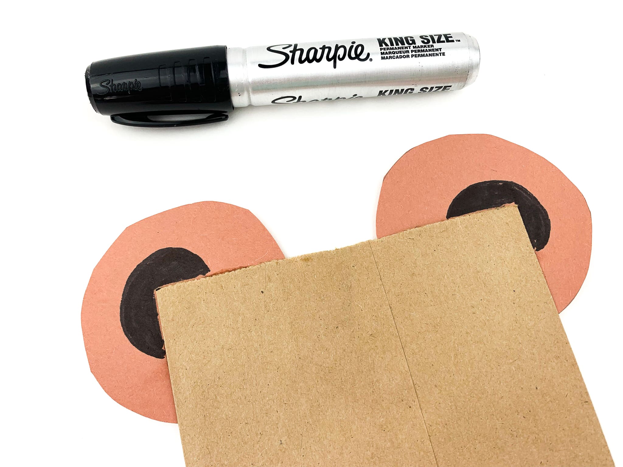 Color in the middle of the ears with a black marker.