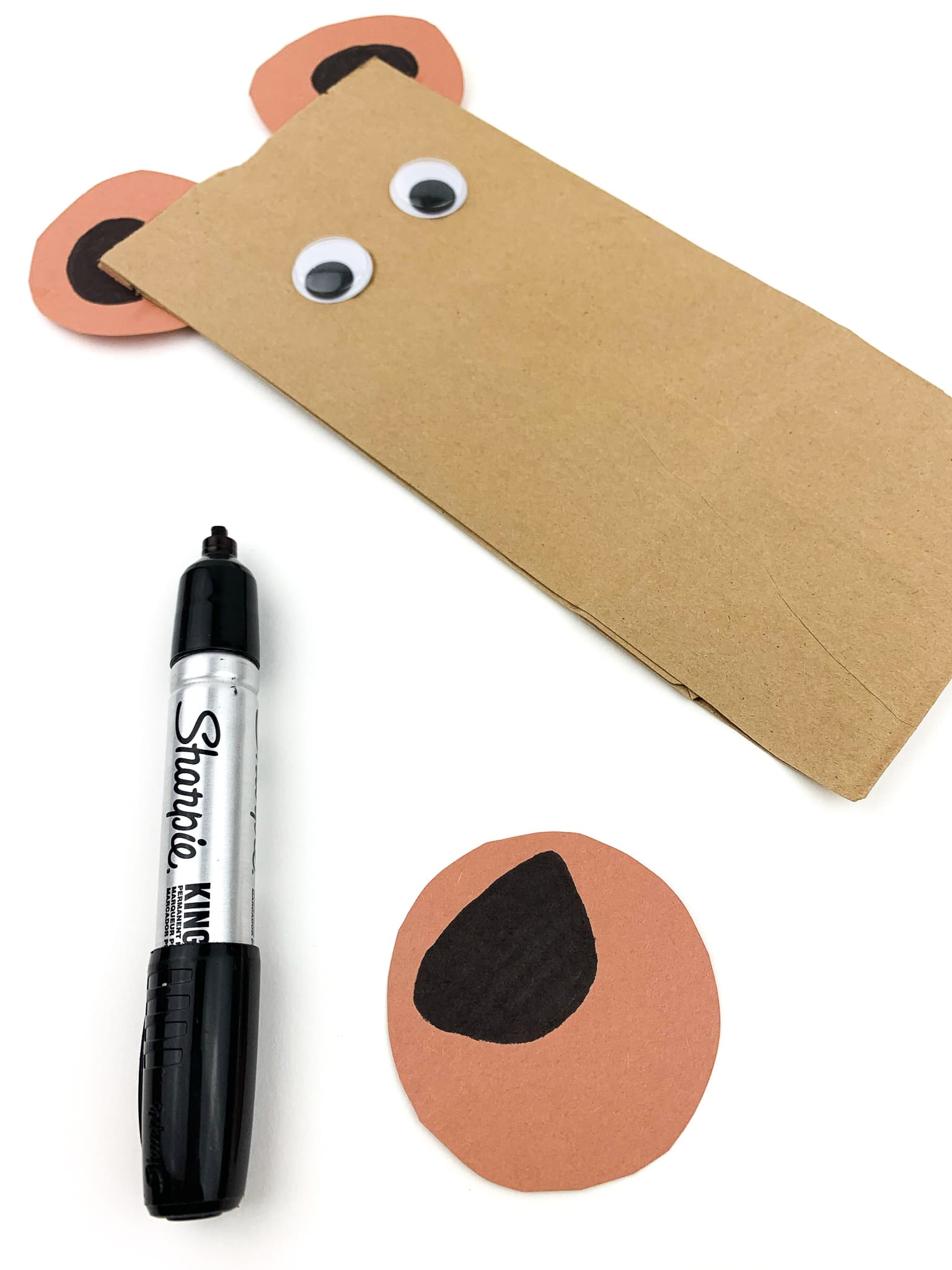 With the third circle, draw a nose and a mouth.