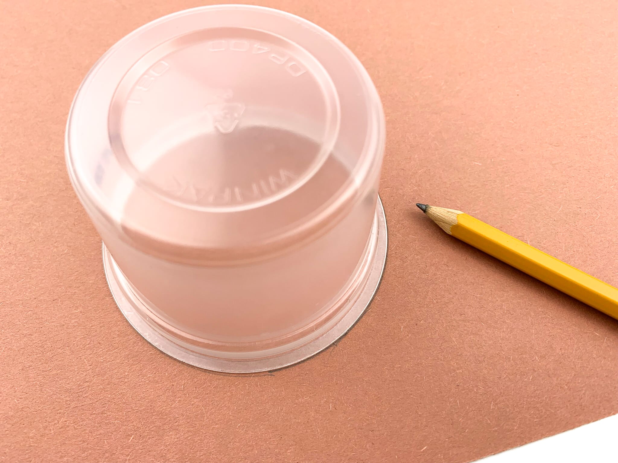 Using the bottom of a cup, trace three circles and cut them out on the brown construction paper.