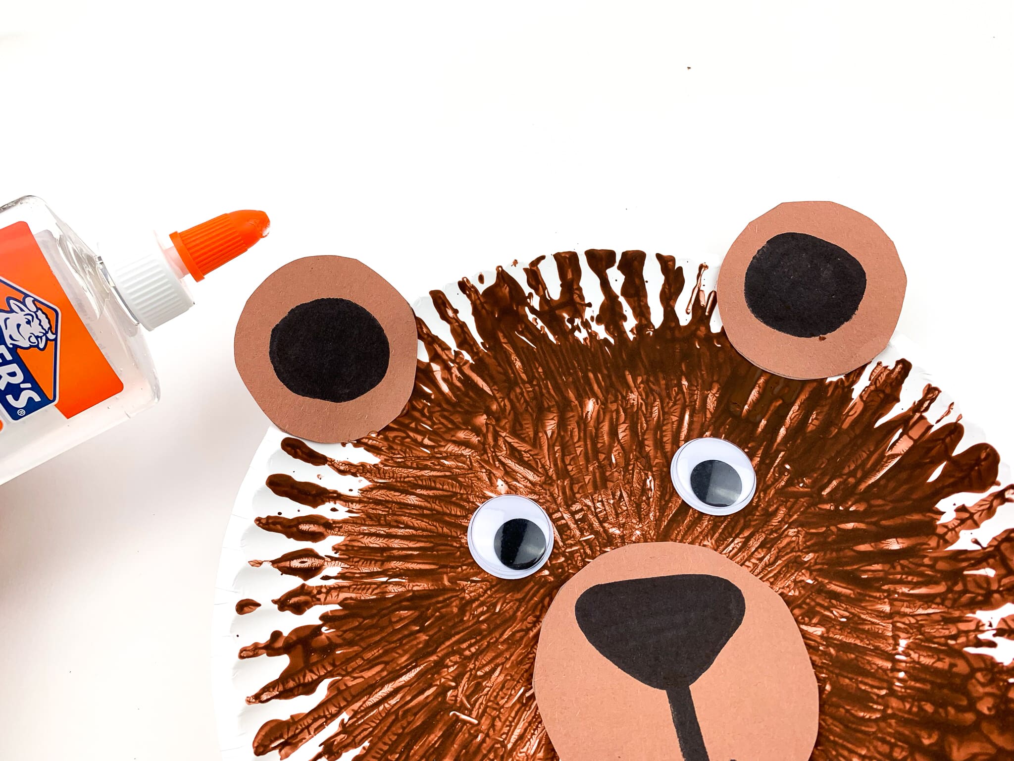 Glue on the ears, eyes and nose to the dried paper plate.