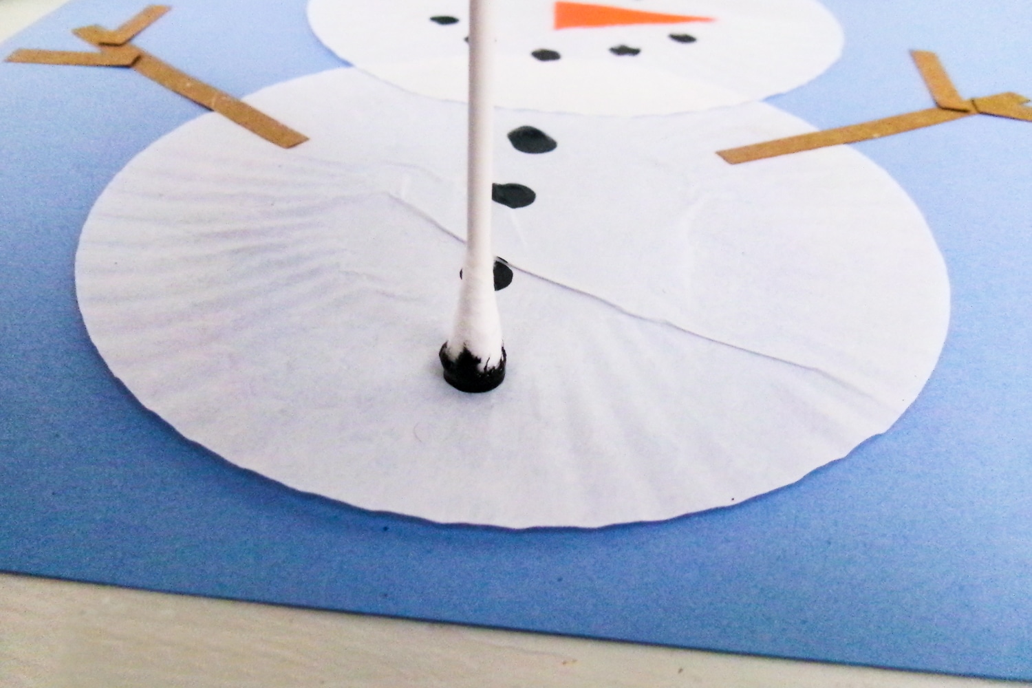 Painting buttons on snowman with qtip
