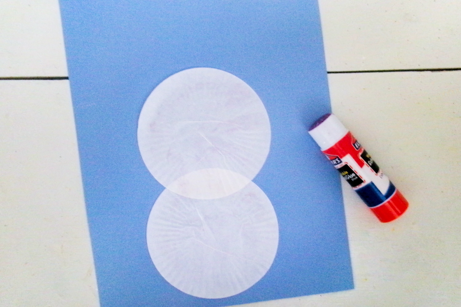 Blue paper with two white cupcake liners