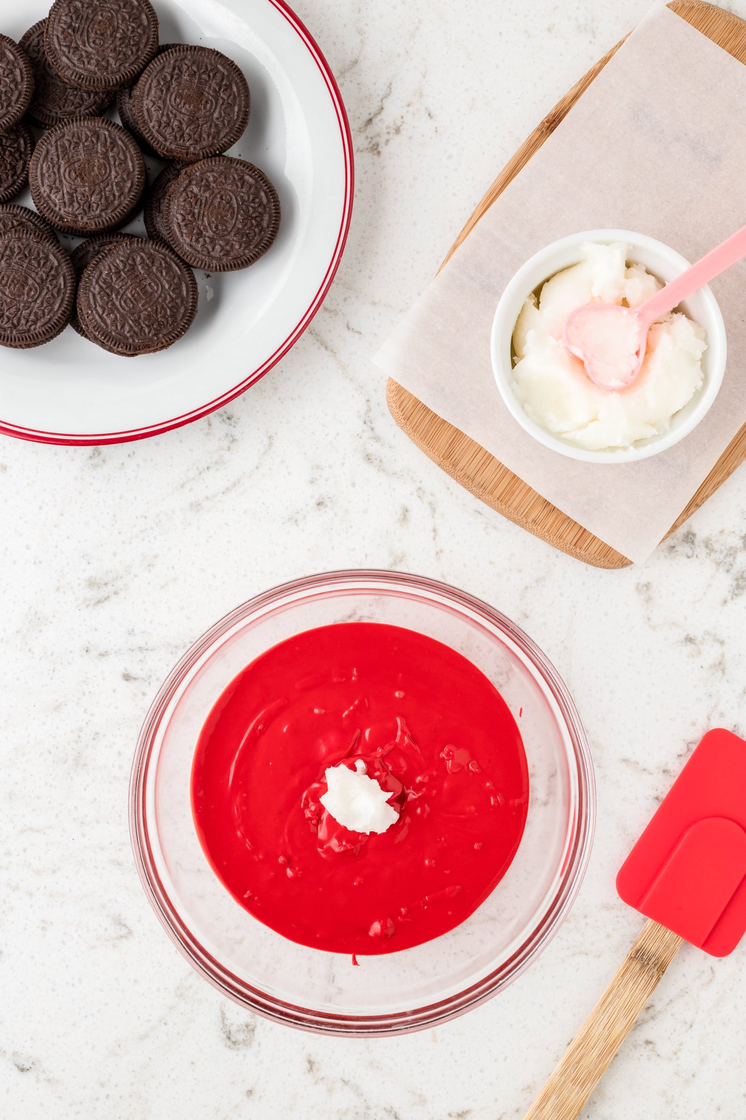 Adding coconut oil to red candy melt for Lady Bug Oreos recipe