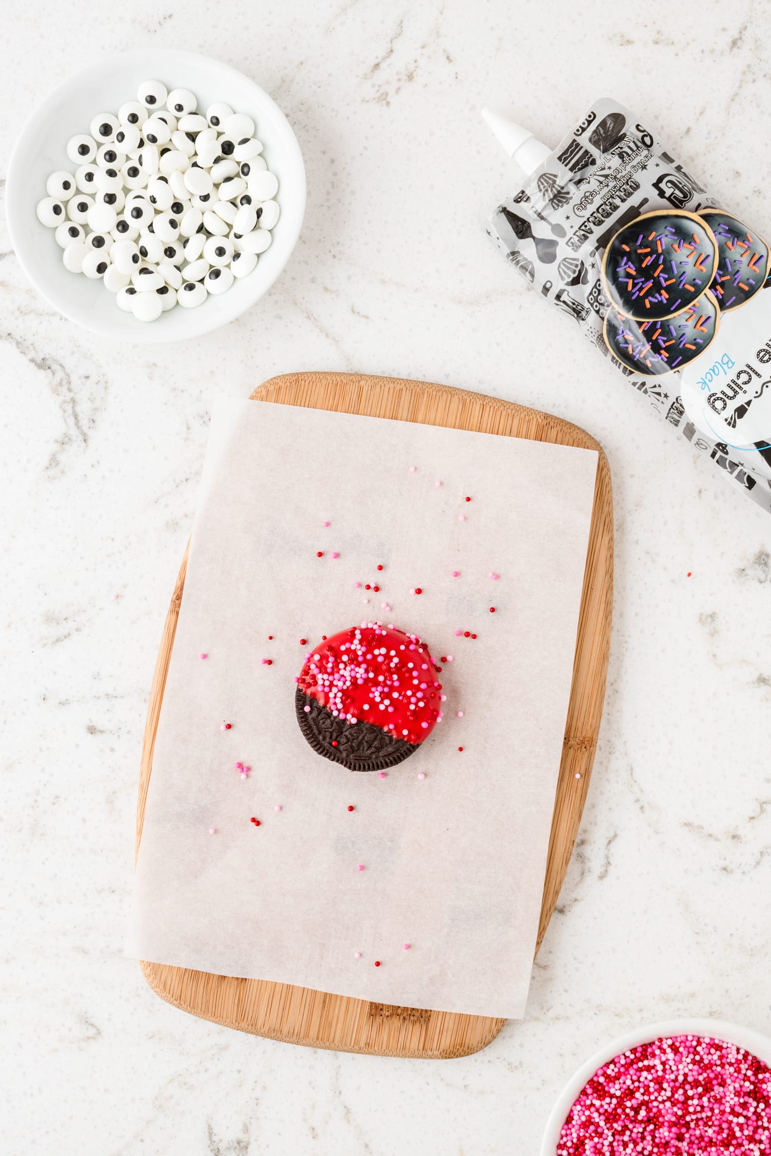 Adding Valentine's sprinkles to candy melt for Lady Bug Oreos