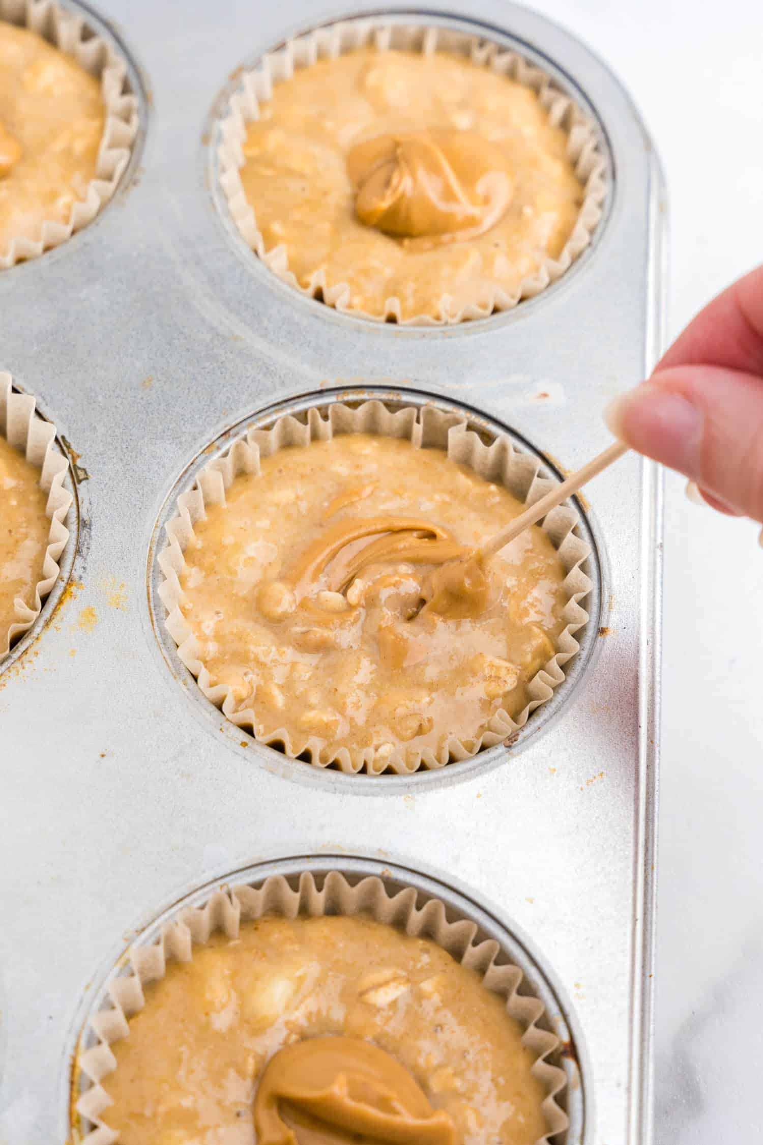 put a teaspoon of peanut butter into each cupcake and mix together with a toothpick.