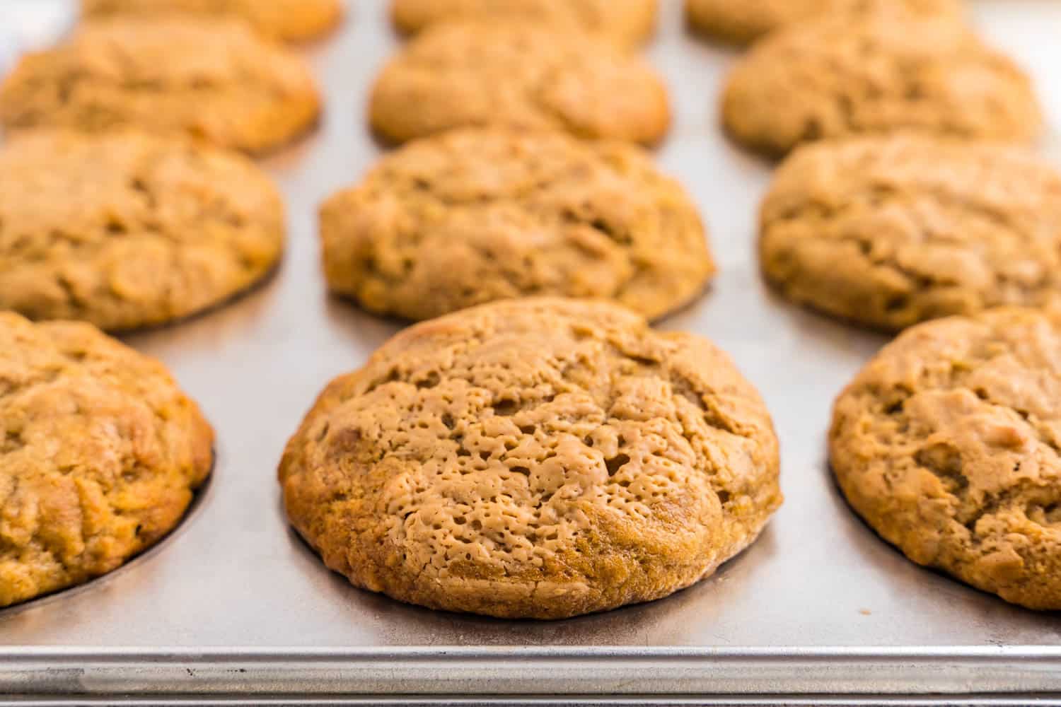 Close up Photo of cooked Banana Muffins in a Cupcake pan.
