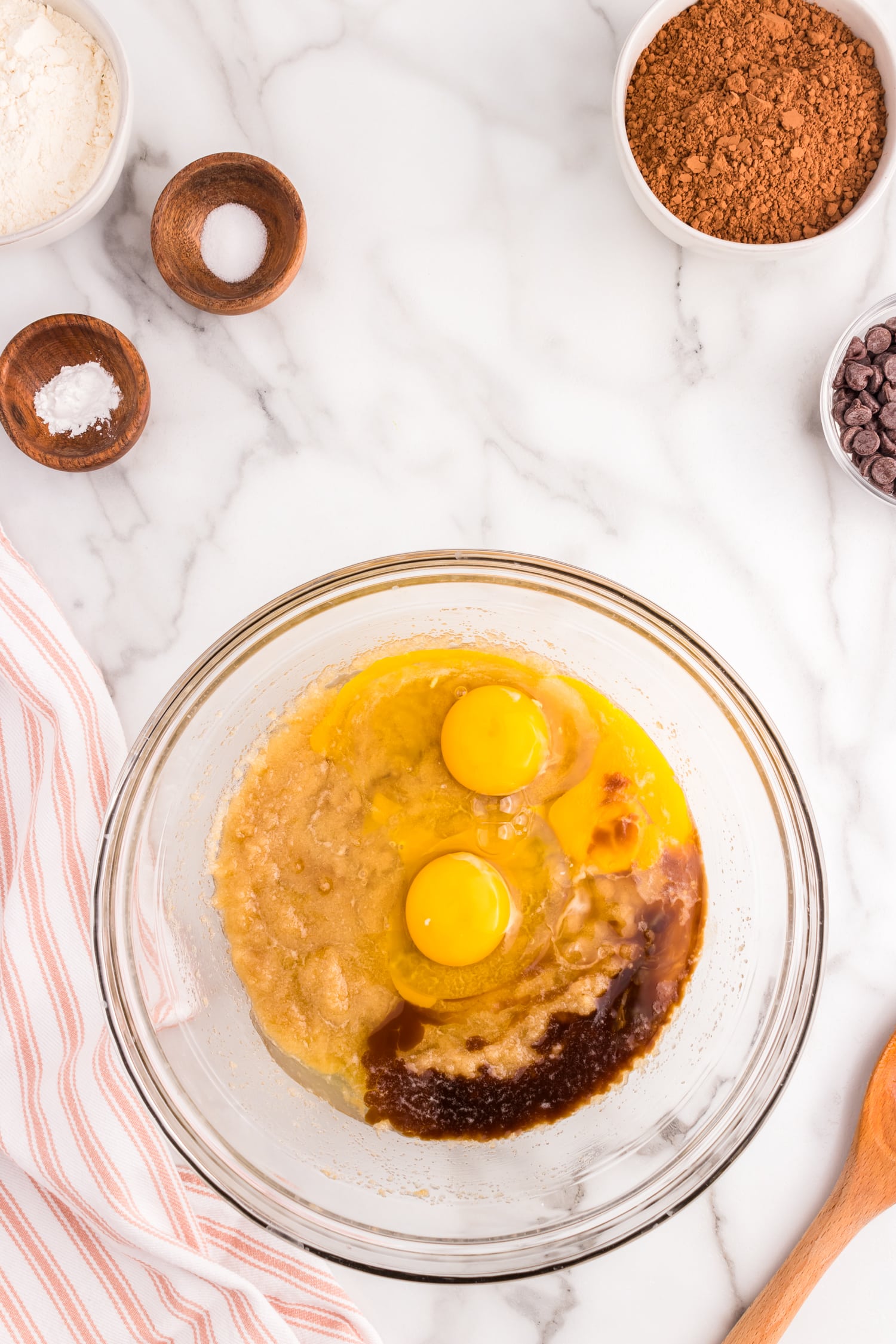 Adding eggs to Homemade Brownies ingredients in mixing bowl