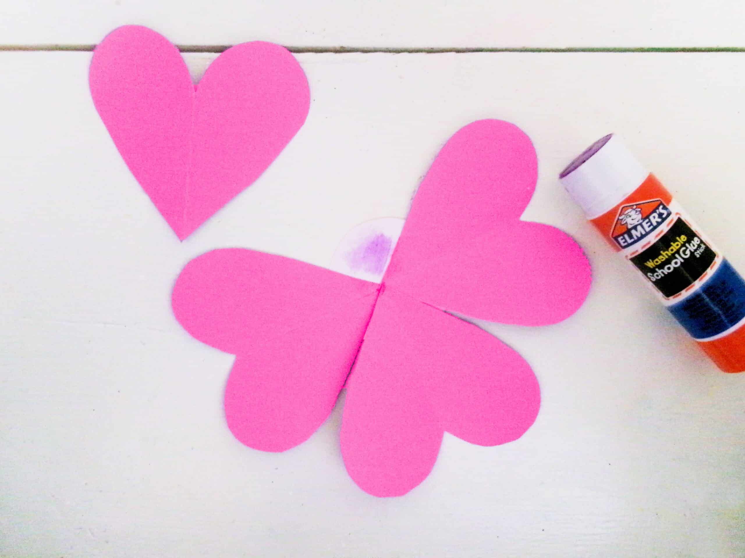 Glue the tips of the hearts to the back of the circle.