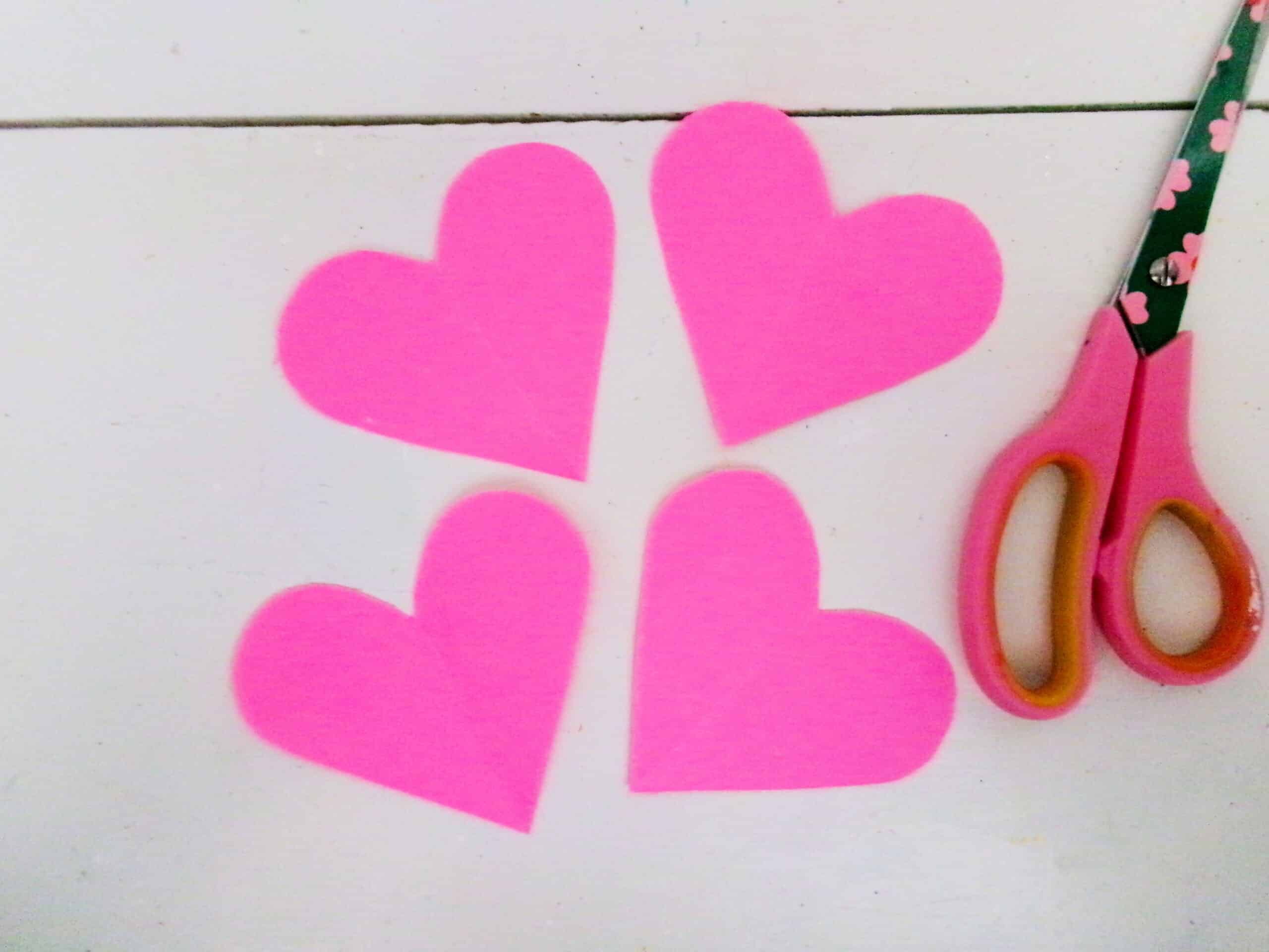 Start by cutting 4 hearts out of your color of choice cardstock paper.
