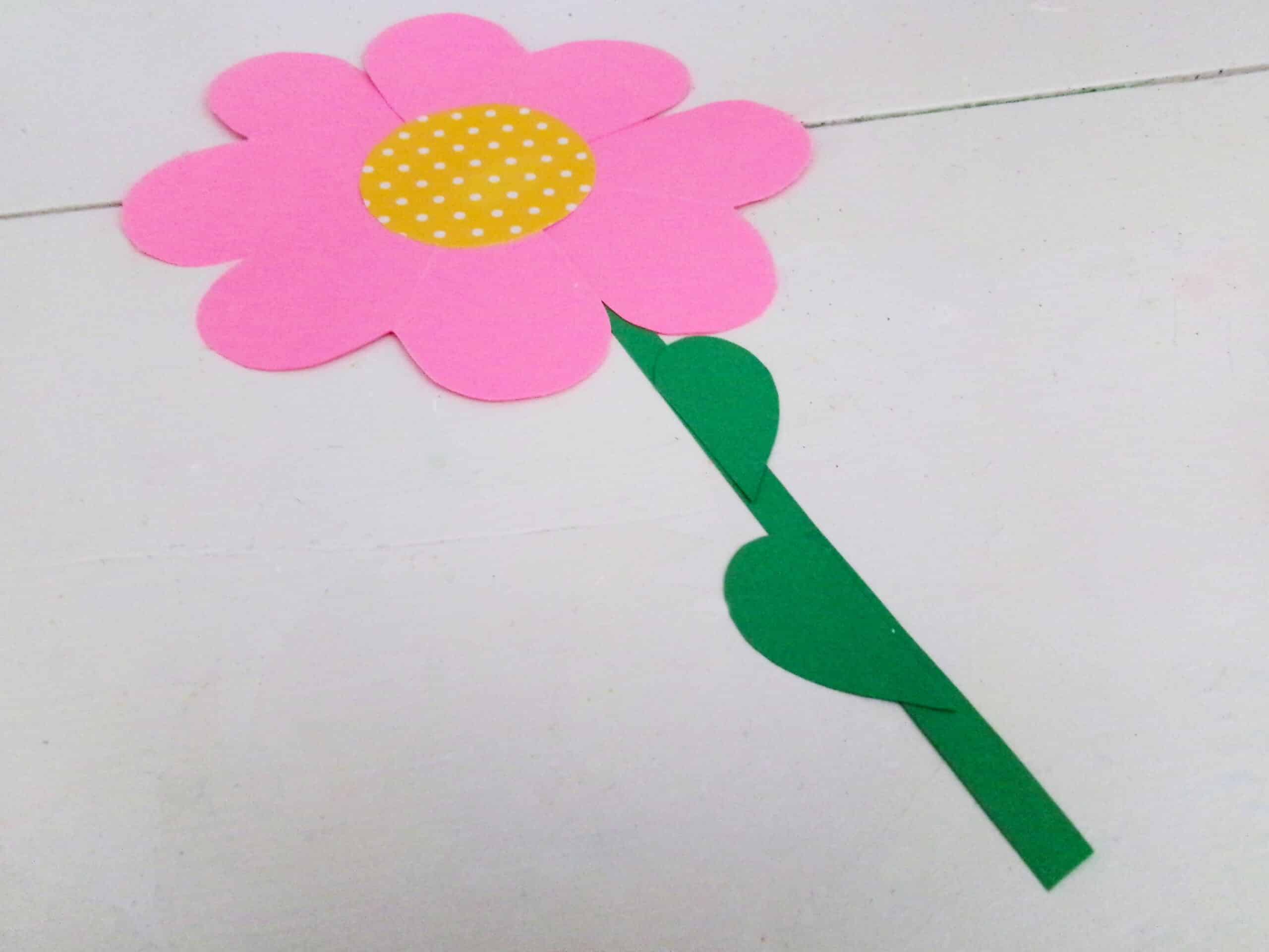 Glue the stem t the back of the flower and glue the leaves onto the stem.