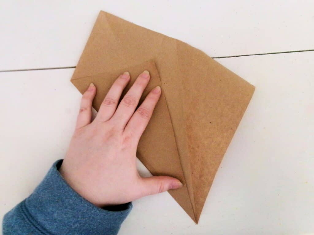 Make a wrap by folding a square piece of brown paper.