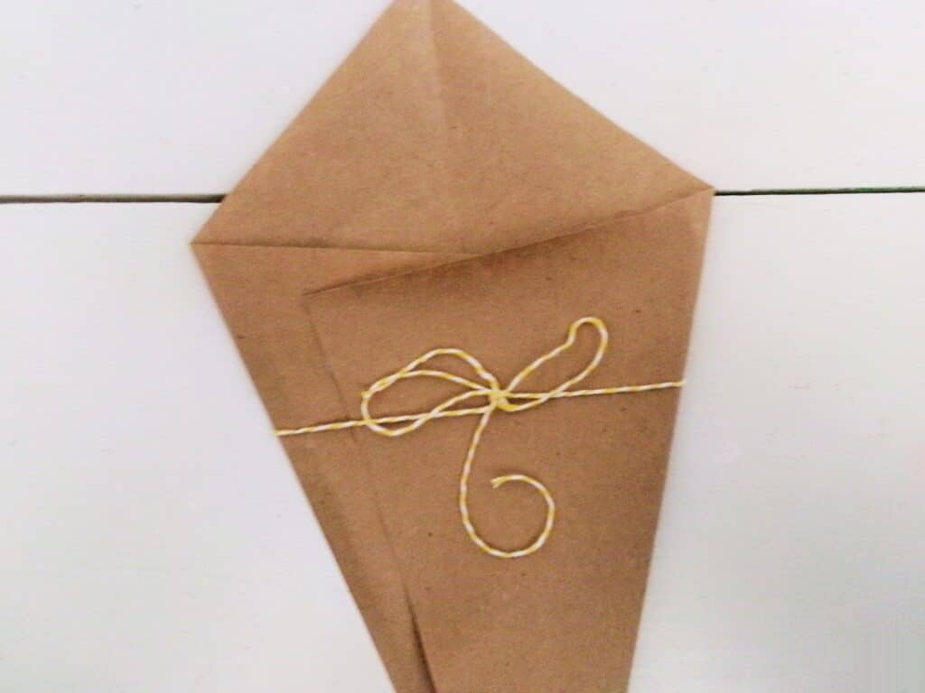 Cut a piece of twine and glue it to the outside for the wrap.