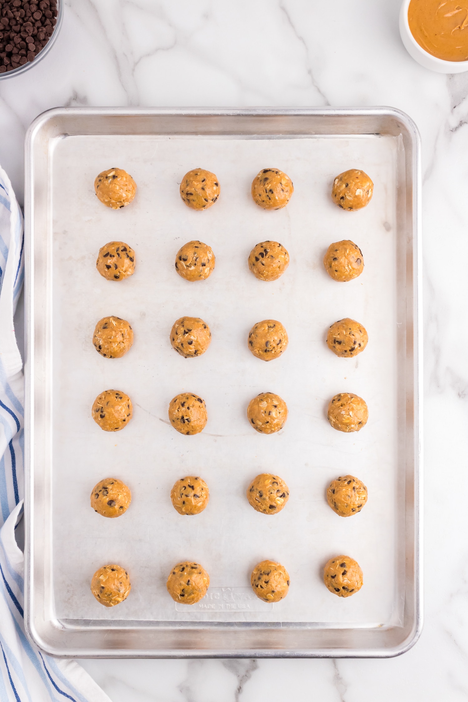 Place energy balls onto a cookie sheet lined with parchment paper to put in the fridge to harden
