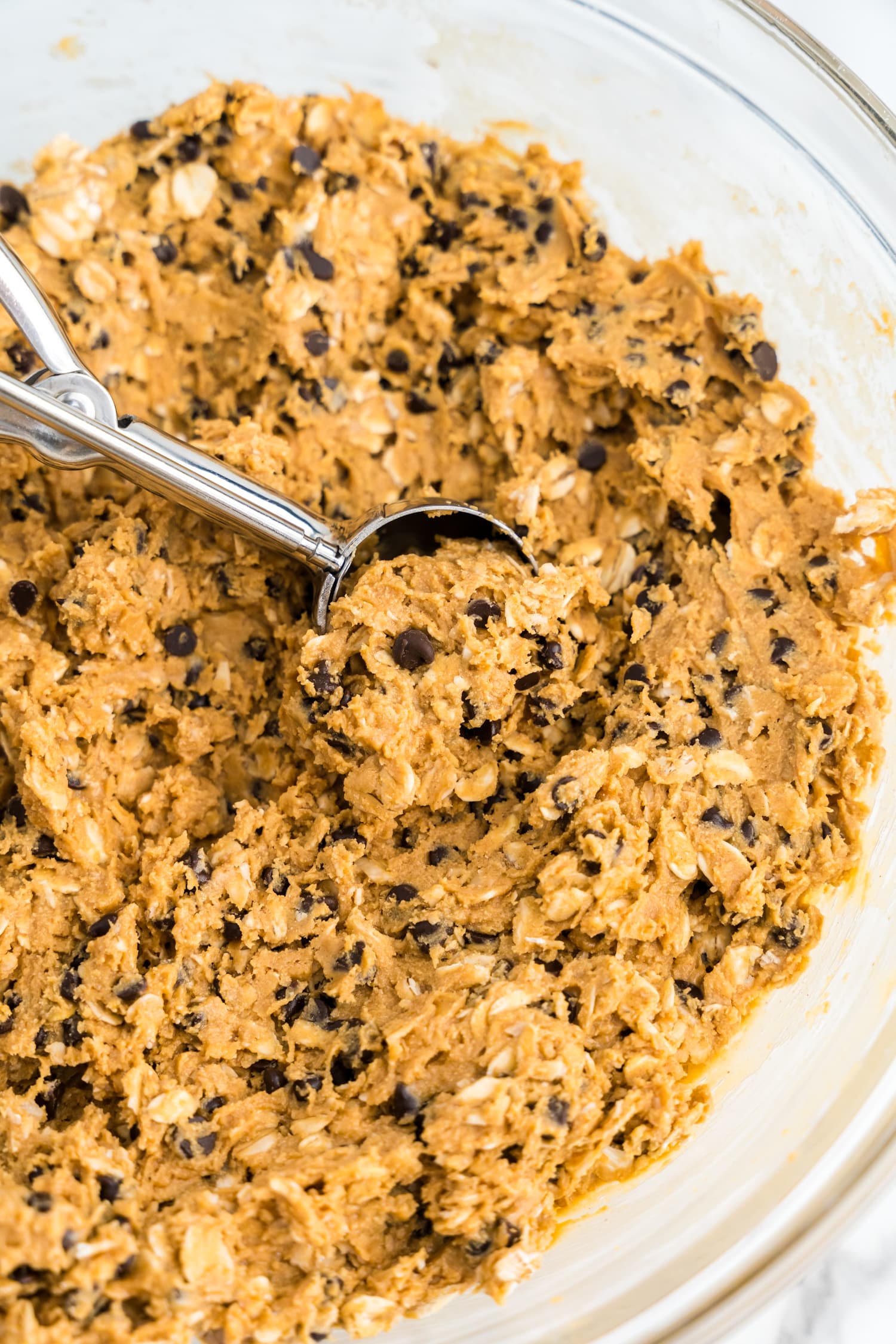 Using a cookie scoop, scoop out energy ball mix & roll into balls.