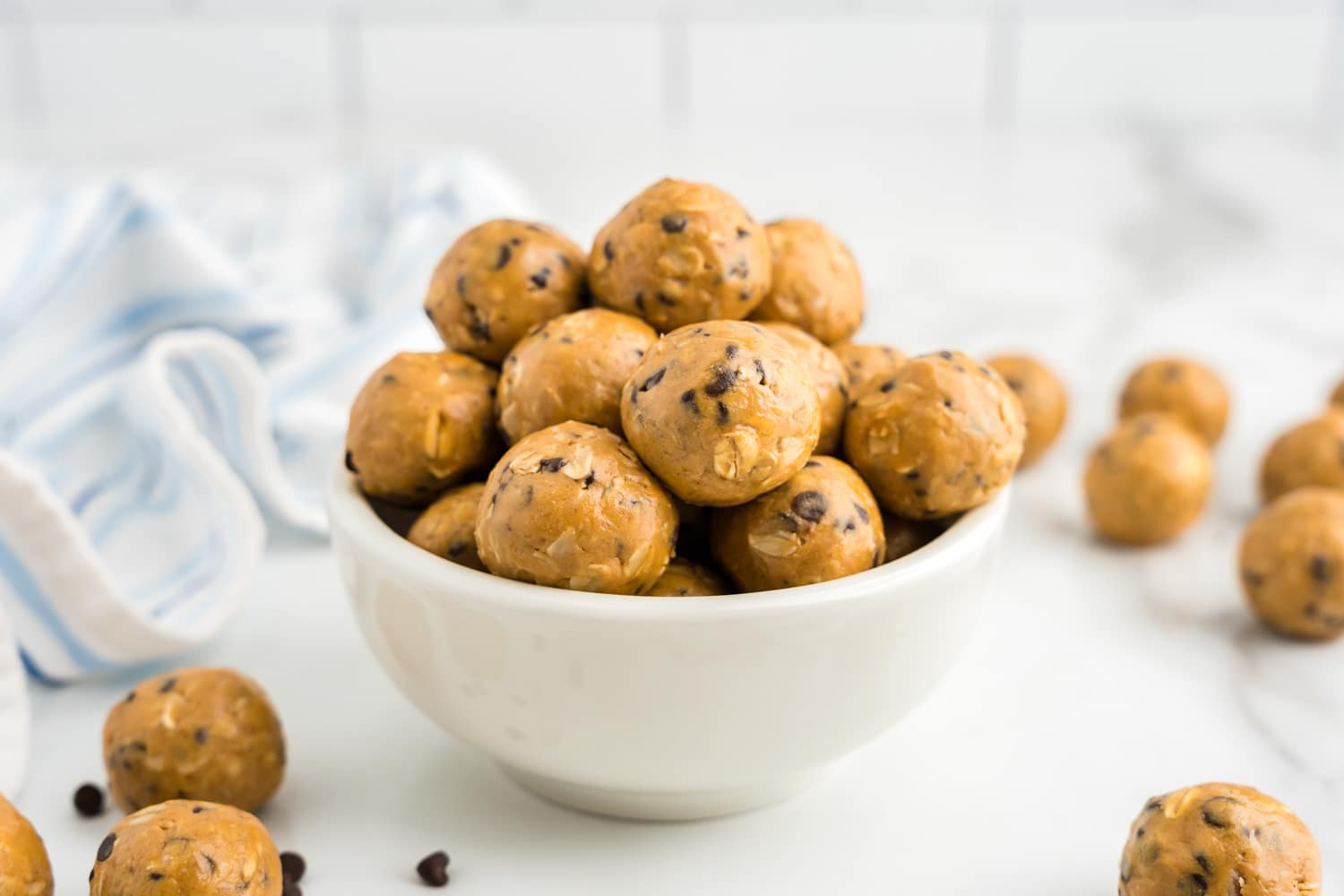 a white bowl filled with energy balls.