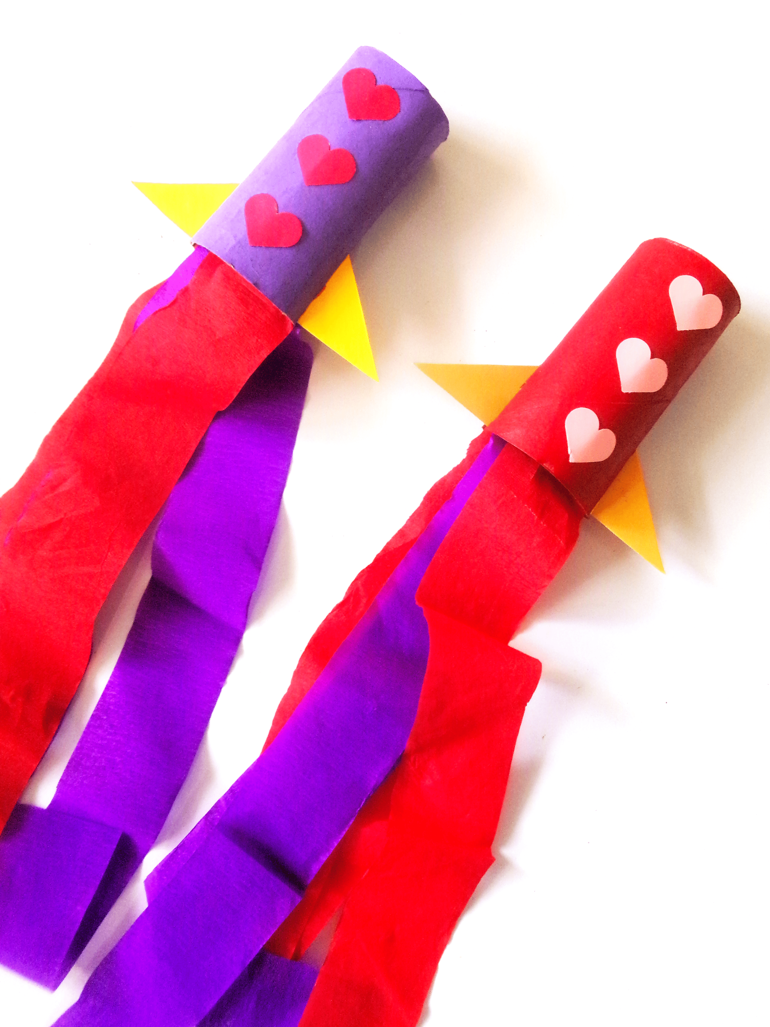 Two completed rockets, each different colors.