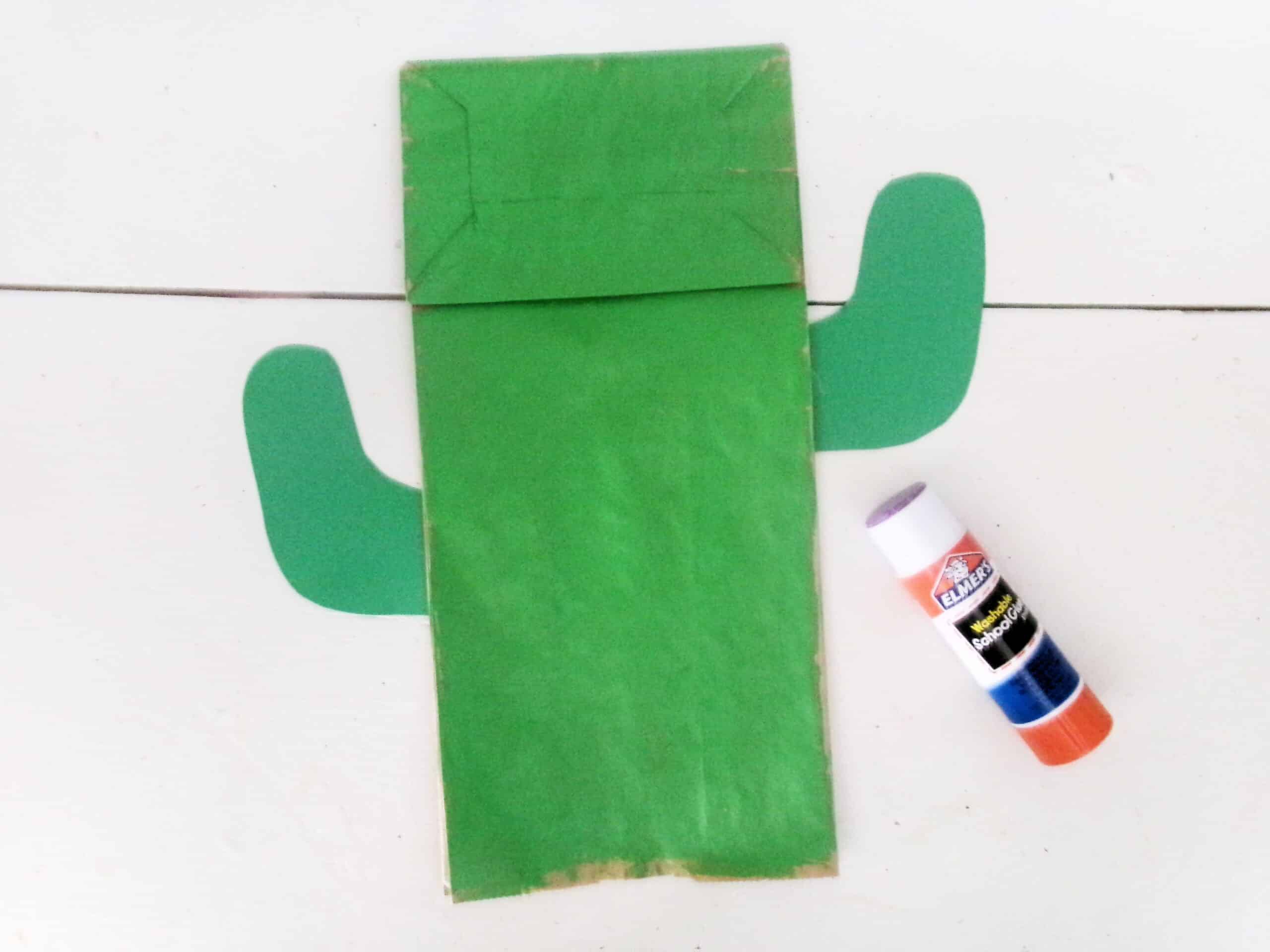 Once the bag is dry, glue the arms on the side of the paper bag.