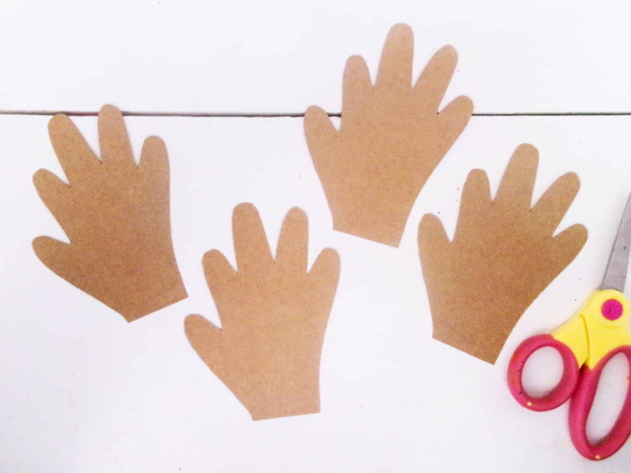 Cut out the four handprints.