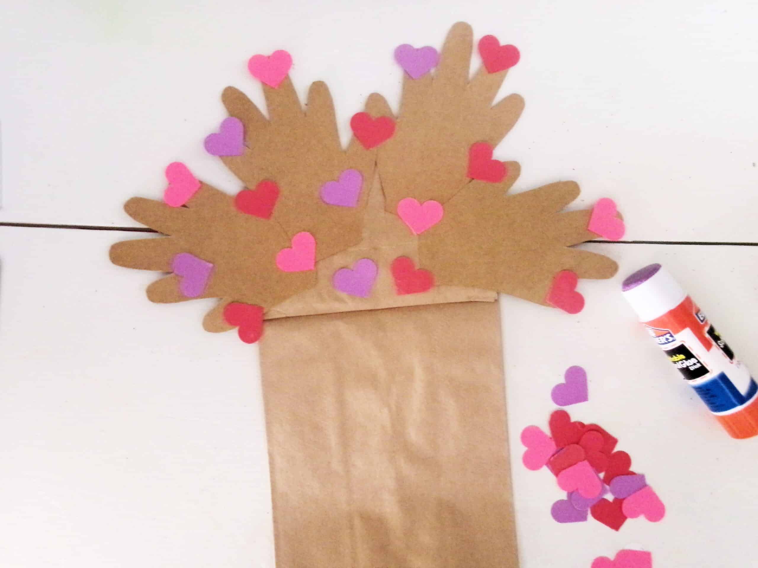 Hole punch a bunch of little hearts and glue them to the tree branches like leaves.