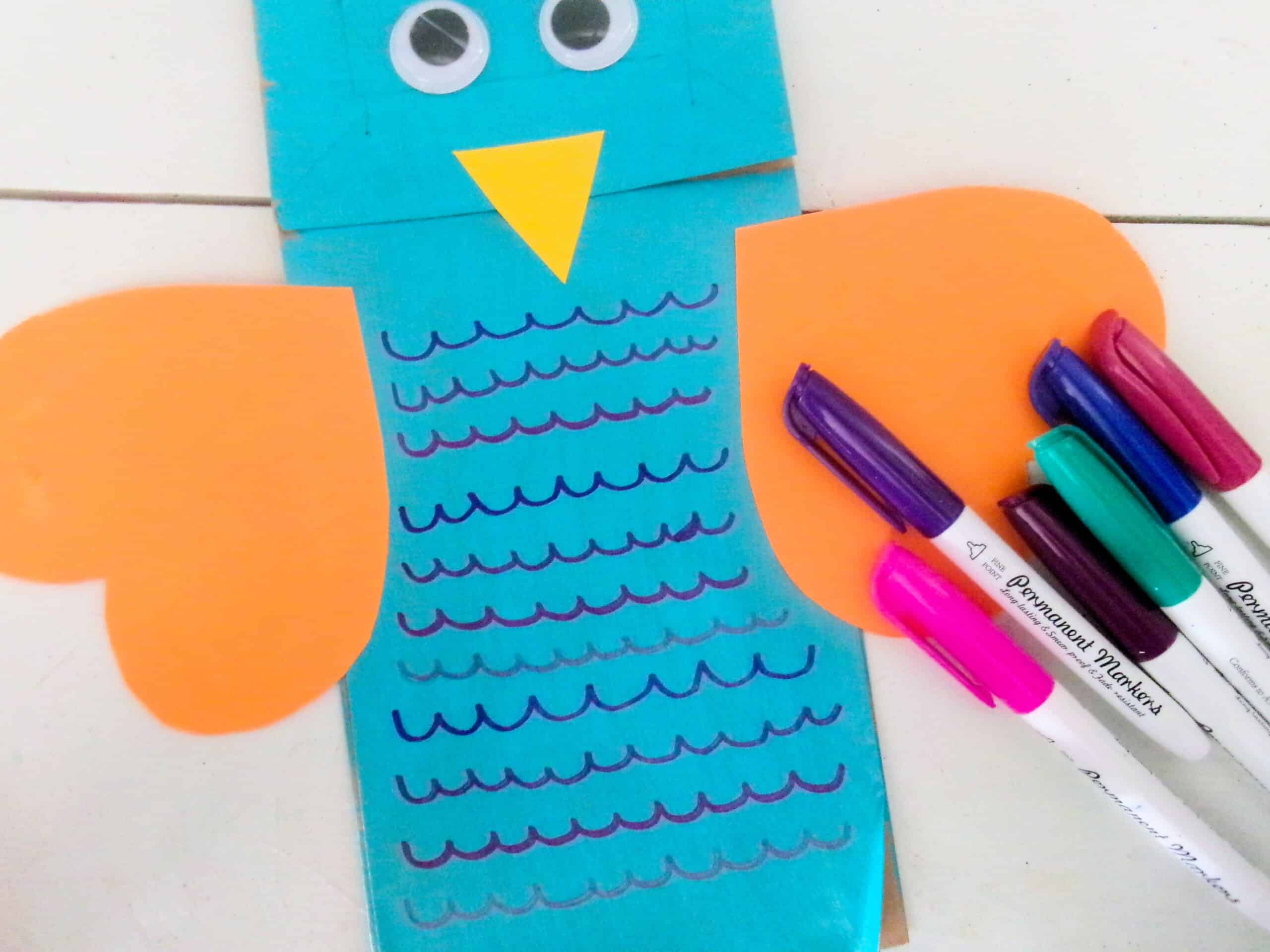 Use the markers to draw details down the front of the front of the body of the bird.