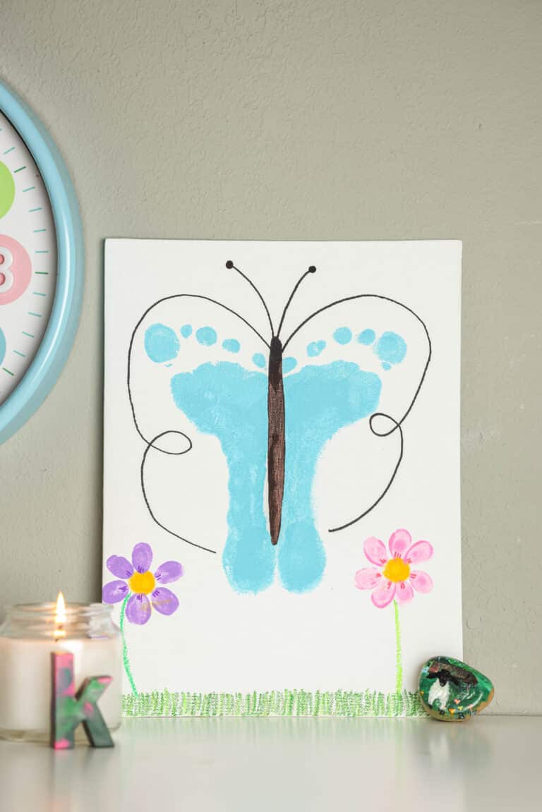 a Completed Butterfly Craft sitting on a desk with decoration around it.