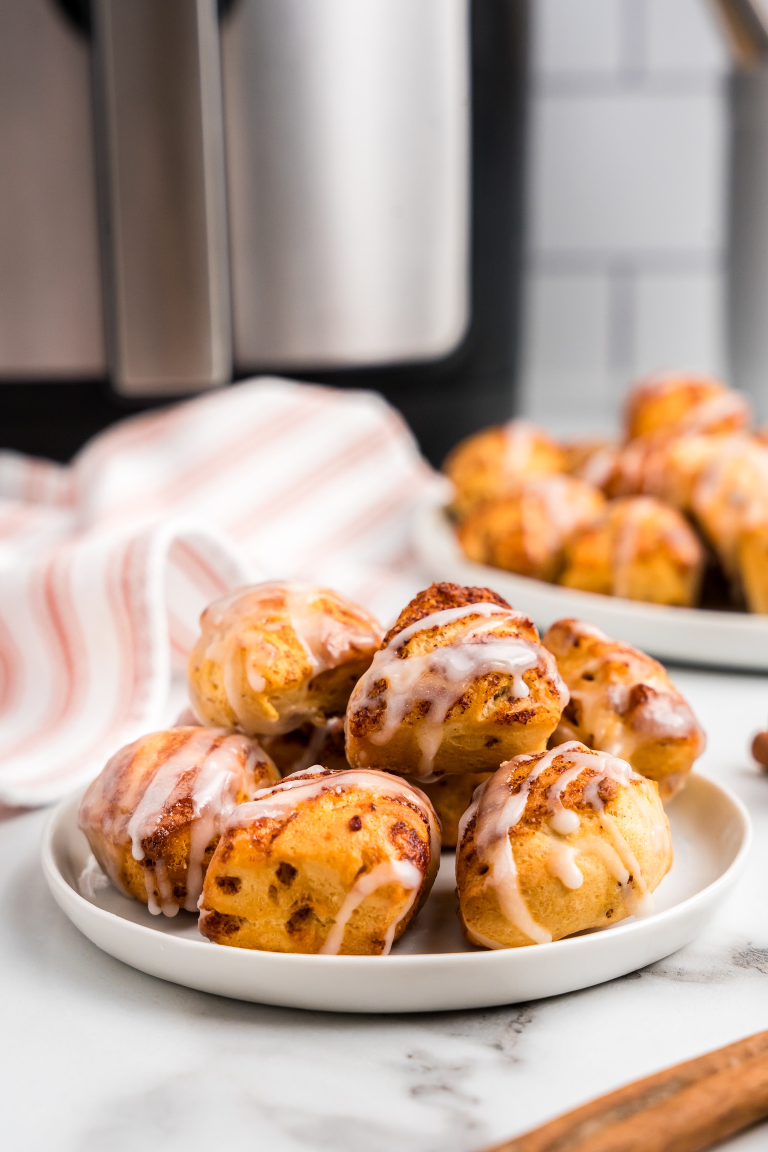 a Small white plate filled with Cinnamon Roll Bites