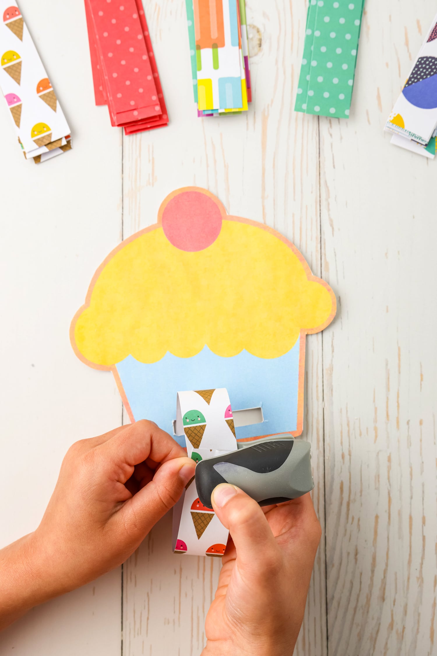 Start by putting the first strip through the cut out at the bottom.