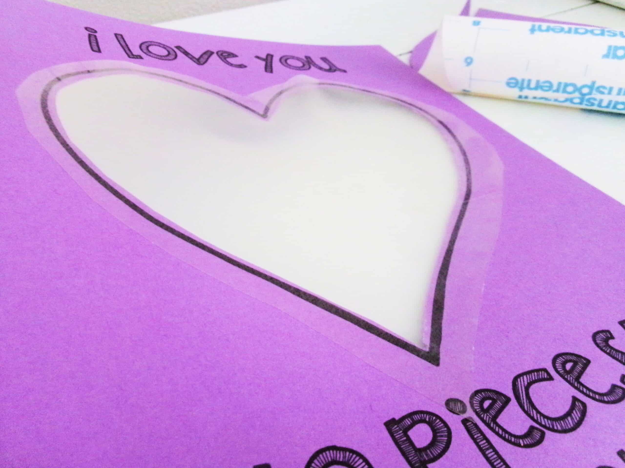 Place one of the cut out hearts on the front of the love you to pieces card.