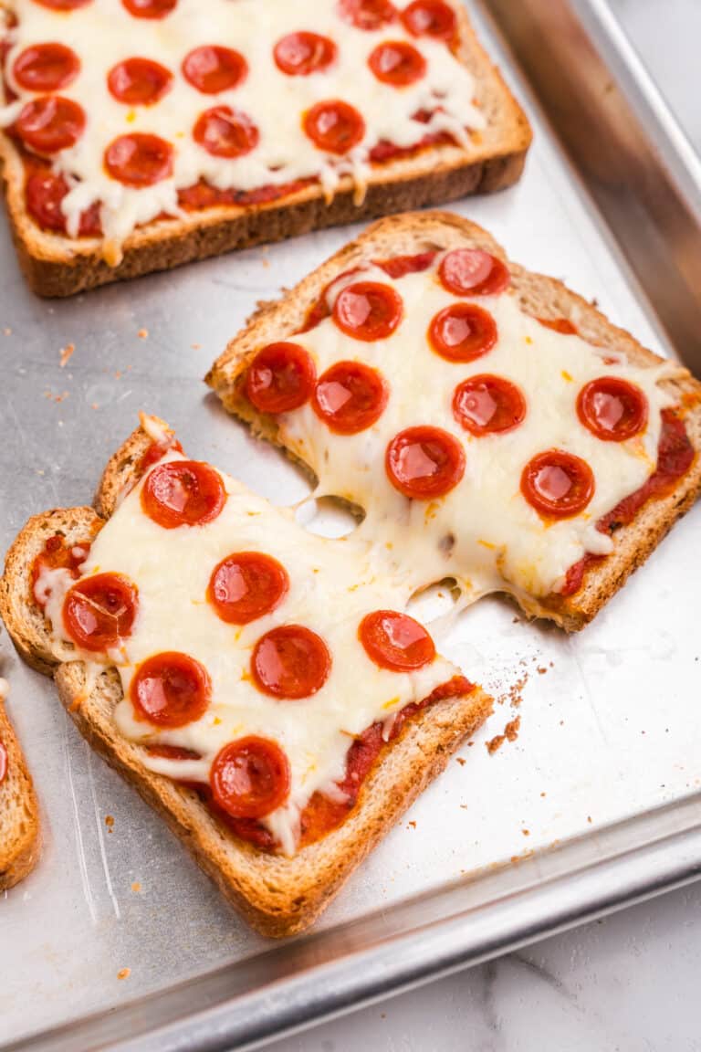 Pizza Toast cut in half on a sheet pan