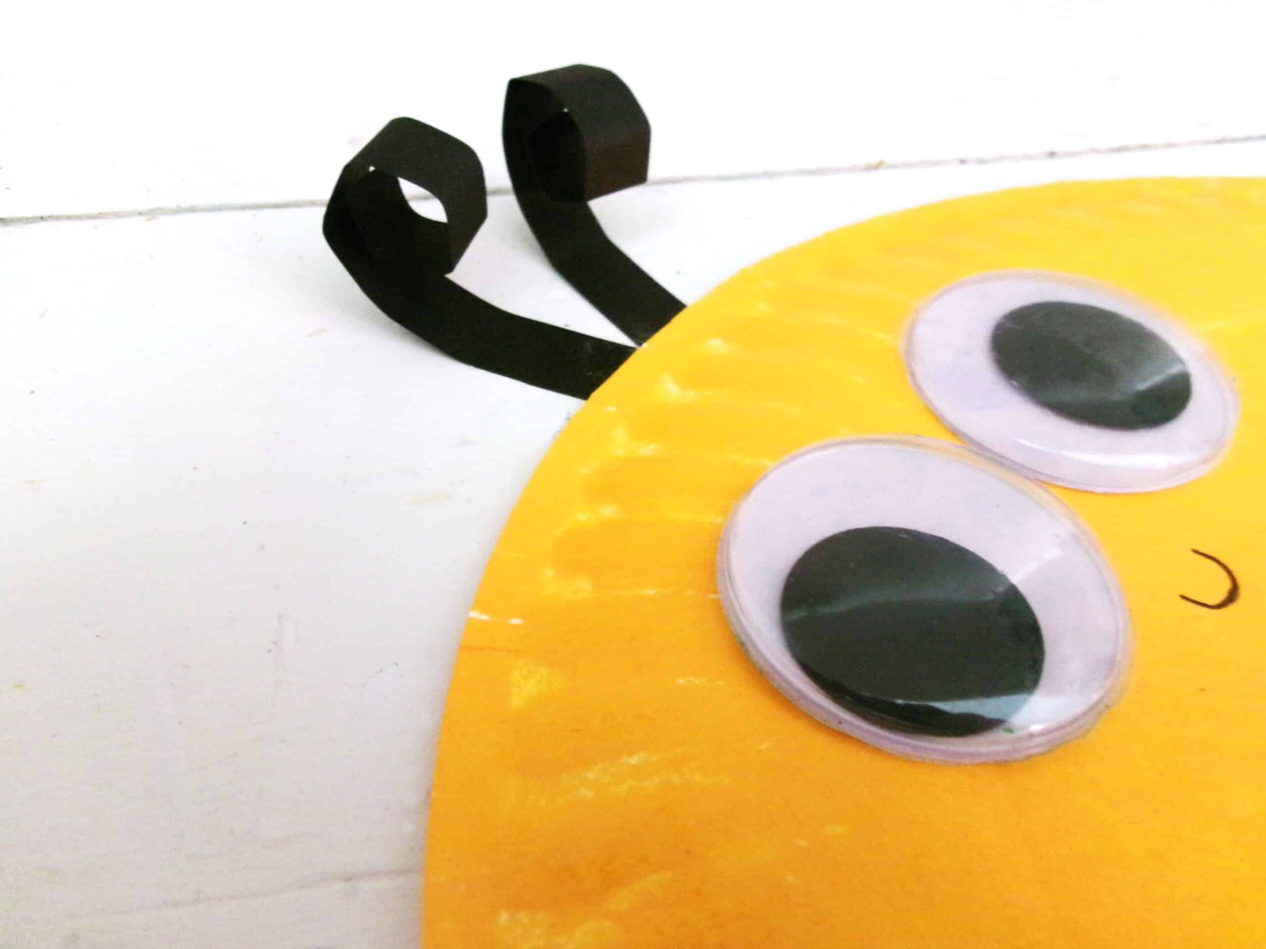 Fold the last stop of black cardstock and glue to the top of the plate to make antennas.