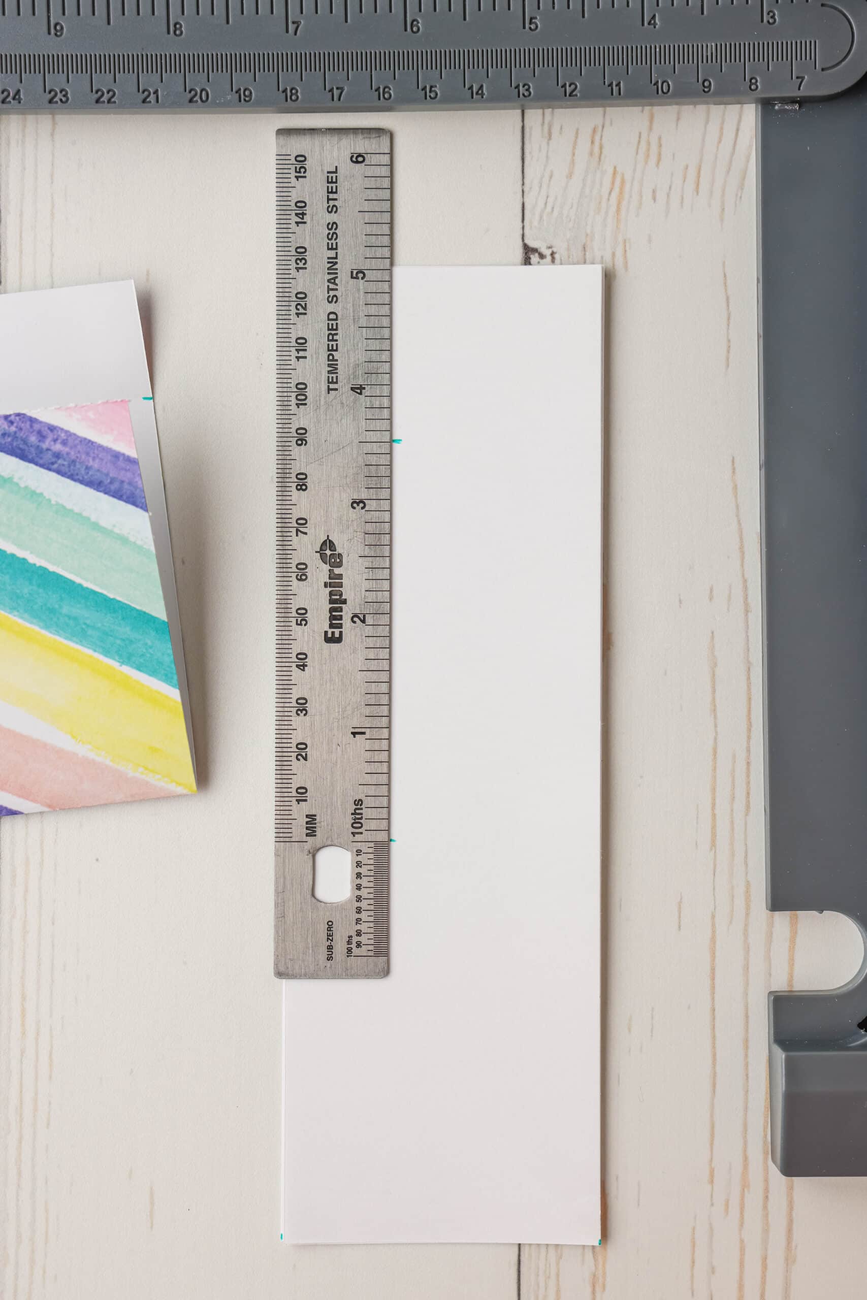 Measure the strips by making marks at 3 &frac12; inches lengthwise. You will be able to make two marks at 3 &frac12; inches with a little paper left over. Cut straight across at the 3 &frac12; inch marks.