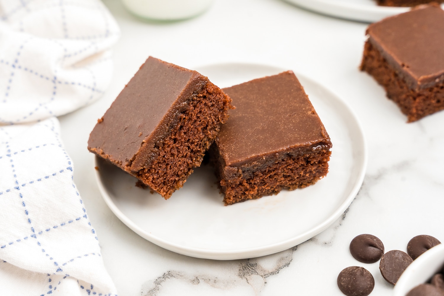 two brownies sitting on a white plate.