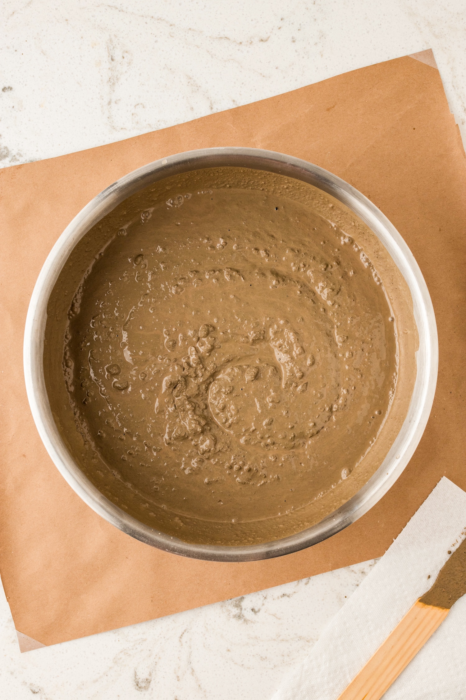 Add 1-2 cups of water to the concrete mix and stir with the stirring stick.