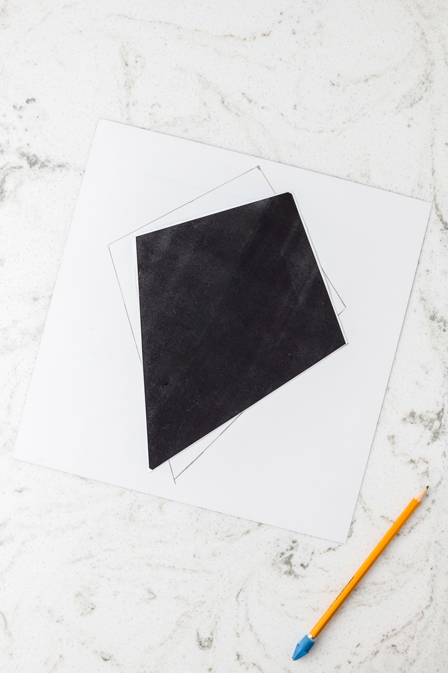 Tracing kite template to the backside of the cardstock with a pencil for the Paper Kite Craft