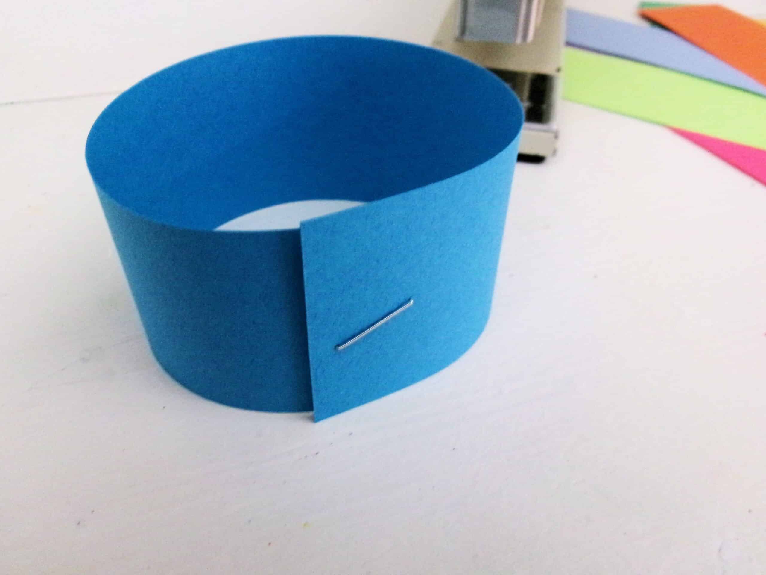 Bring the ends together and form a loop. Staple them together.