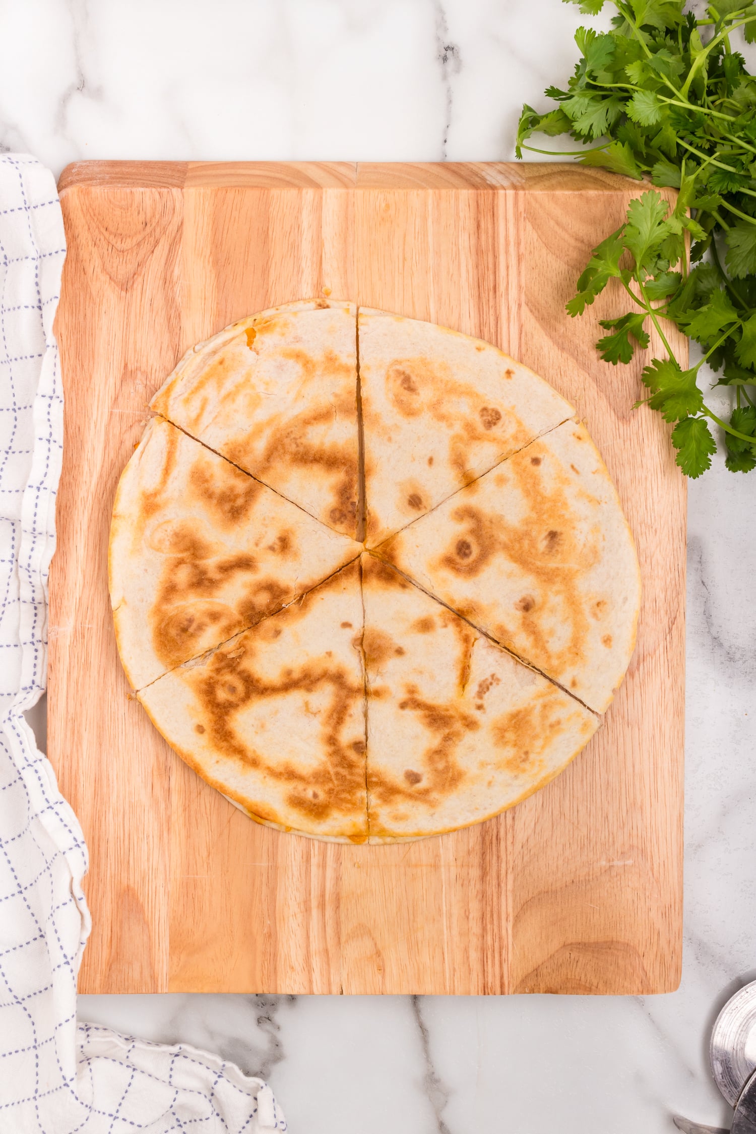 Cheese Quesadilla cut into 6 triangles on cutting board