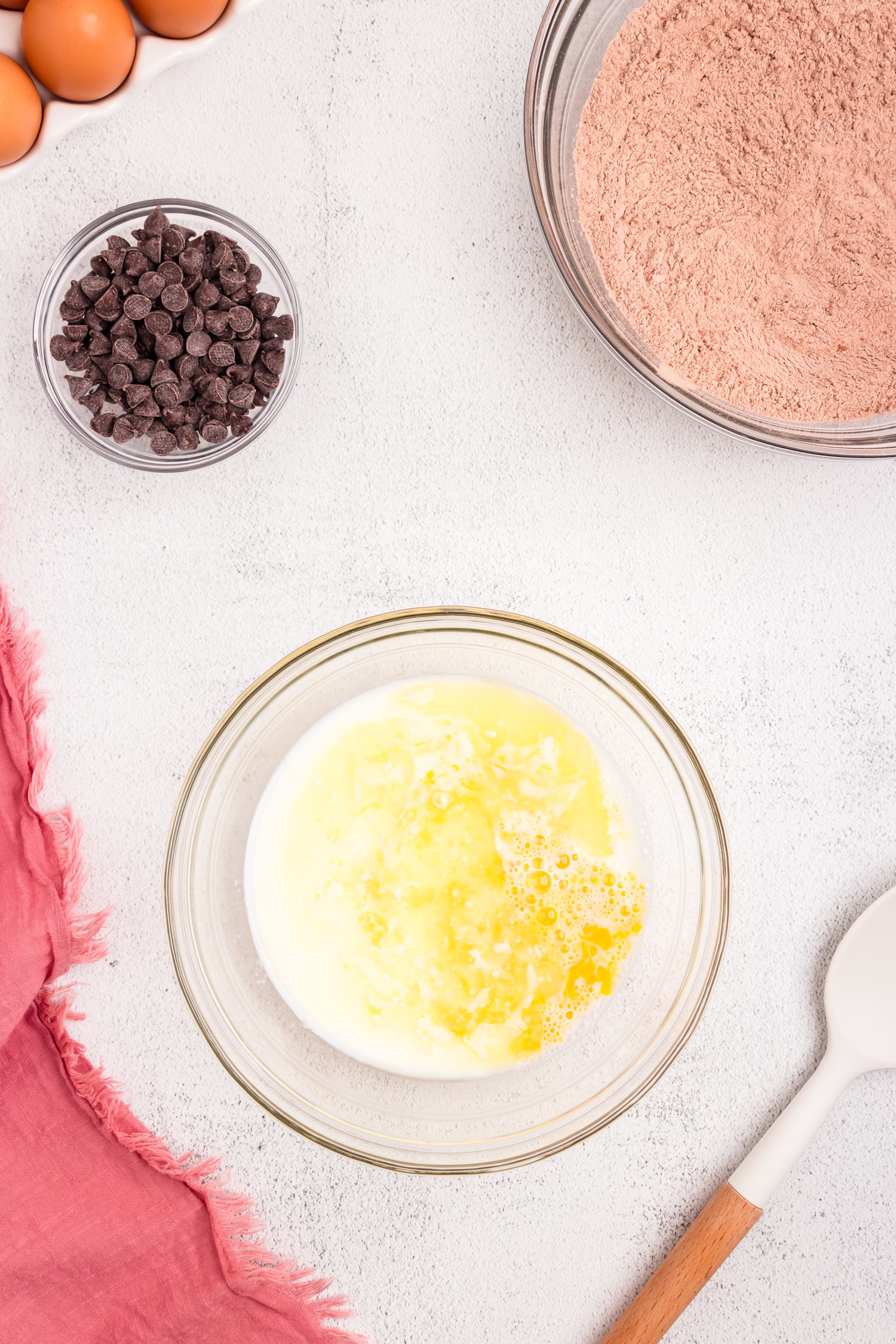 Combining wet ingredients for Chocolate Pancakes in mixing bowl