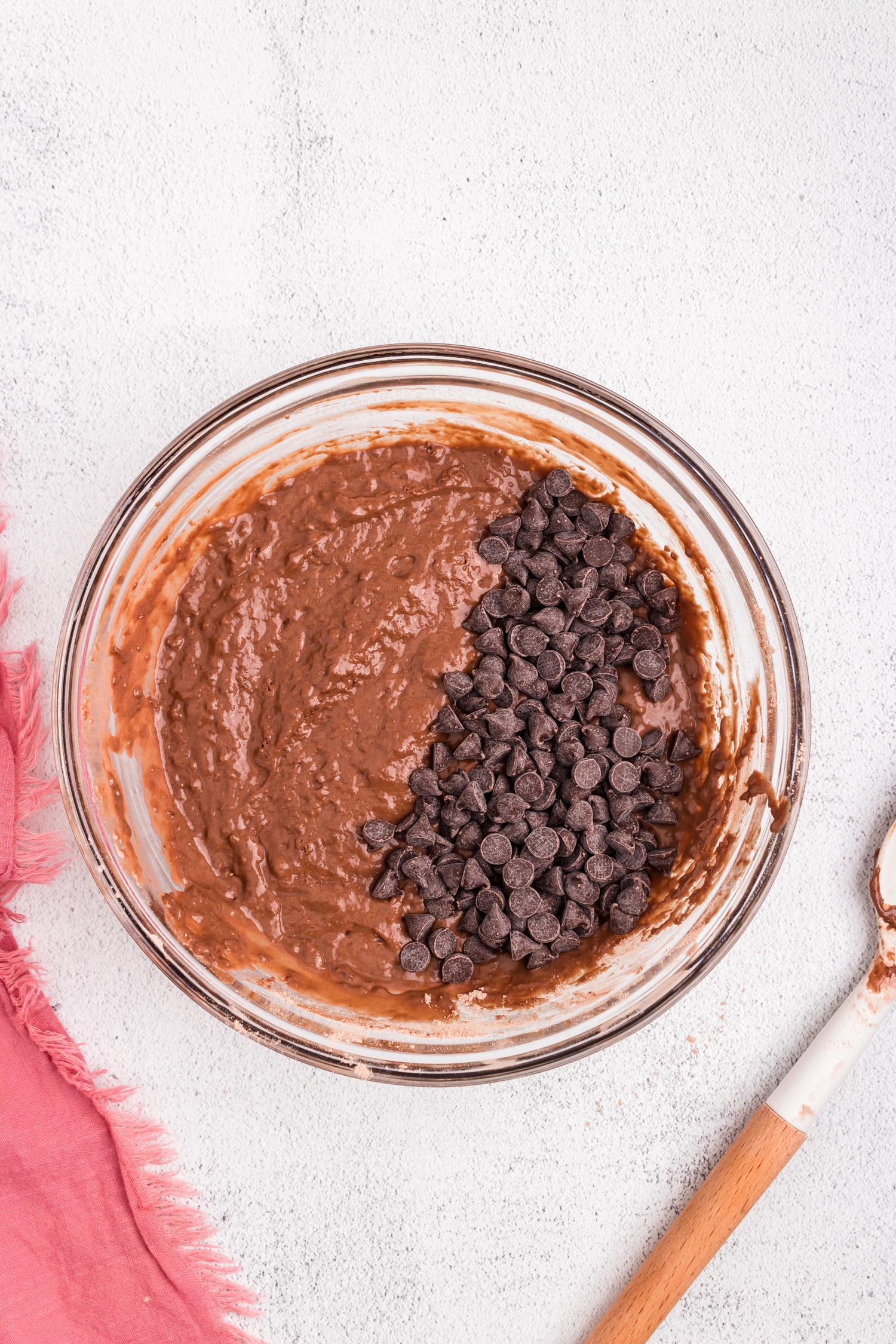 Adding chocolate chips to Chocolate Pancakes batter in mixing bowl