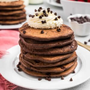 Closeup square image of Chocolate Pancakes stacked on plate
