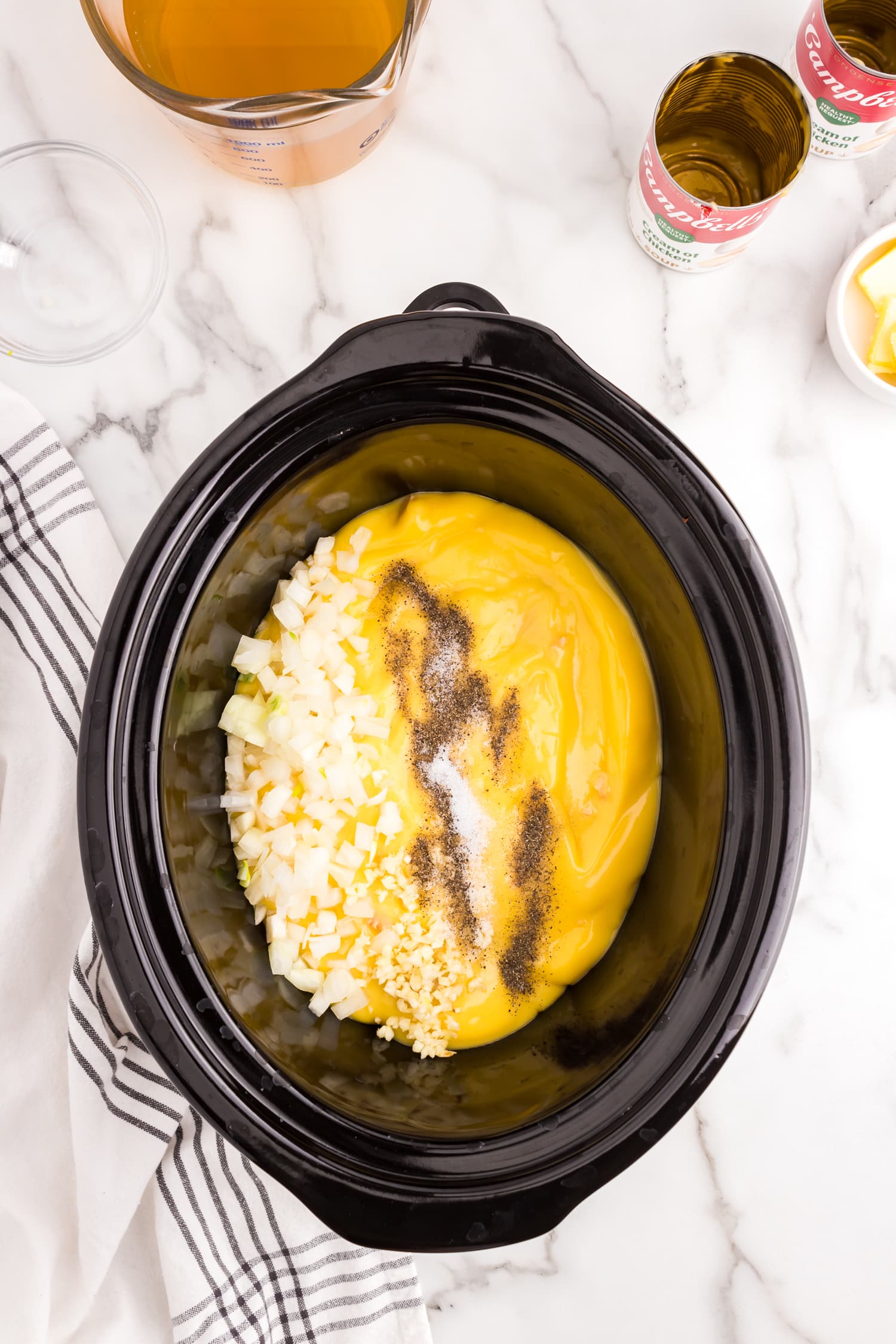 Adding ingredients to crock pot for Chicken breasts in crock pot for Crock Pot Chicken and Noodles recipe