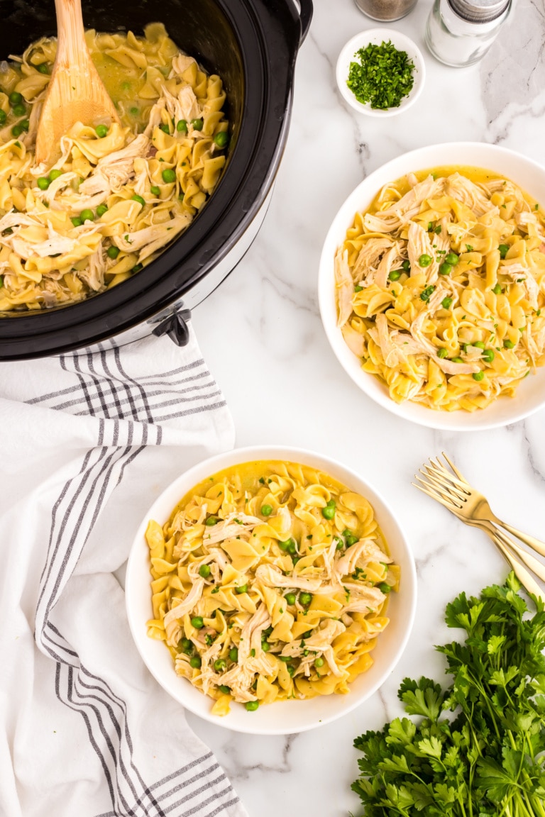 Crock Pot Chicken and Noodles in crock pot and in serving bowls