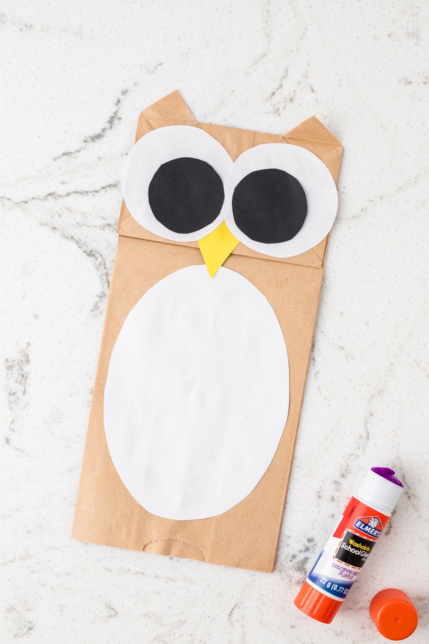 Glusing down a large white oval for the Paper Bag Owl Craft