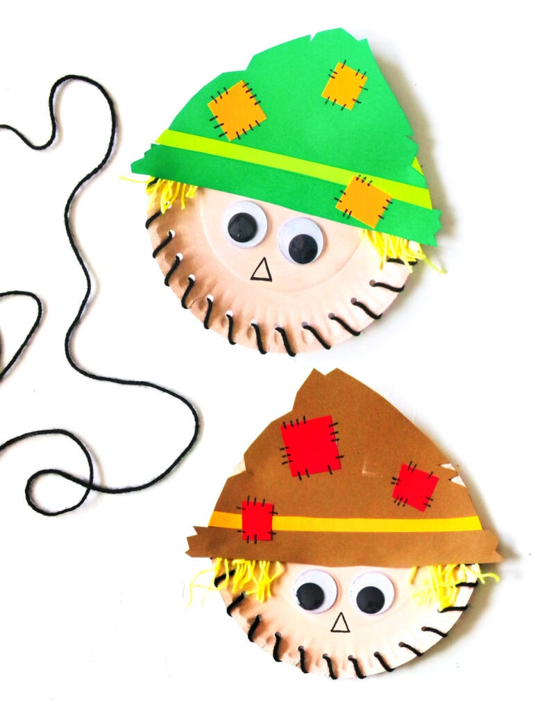 Paper Plate Scarecrow Crafts showing two different hat colors with winding black yarn