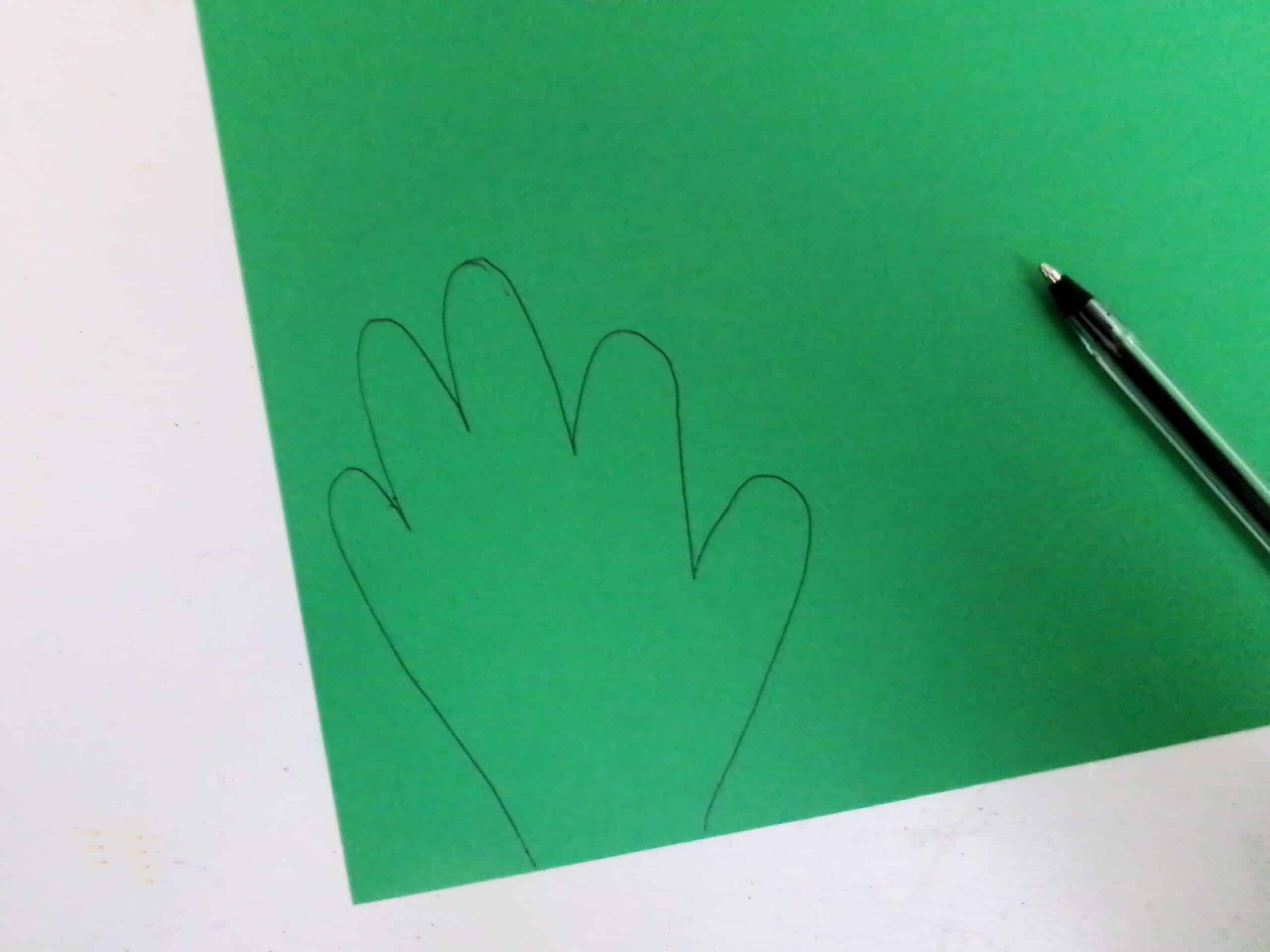Trace your hand on a green sheet of cardstock.