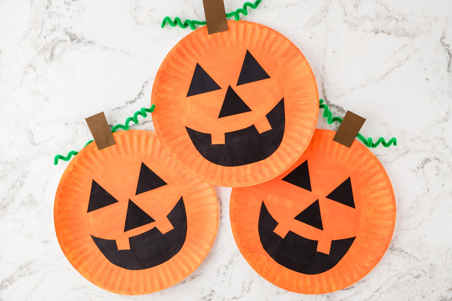 Finished Paper Plate Pumpkin Craft arranged on counter