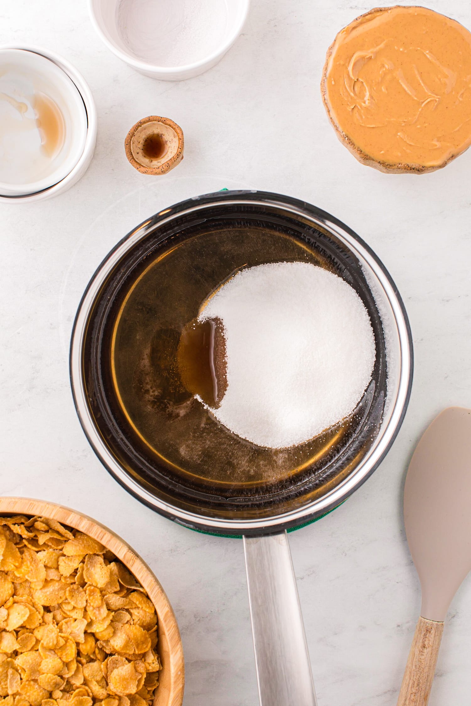 In a Medium Sauce pan pour in the corn syrup & maple syrup. Stir occasionally until bubbling. Take off heat and mix in sugar and vanilla extract.