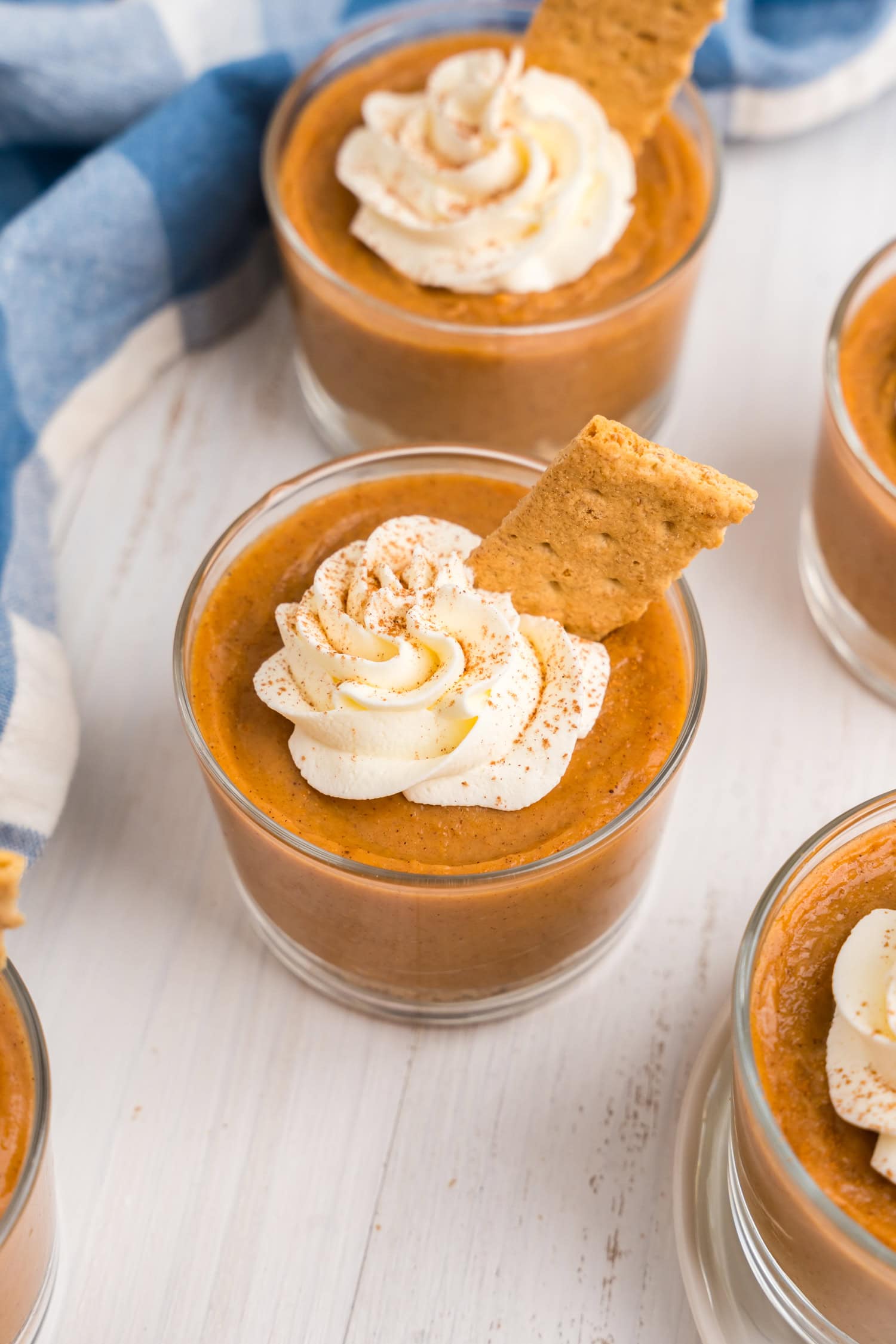 Pumpkin Pie in a Bag layered in small glass cup topped with whipped topping and graham cracker