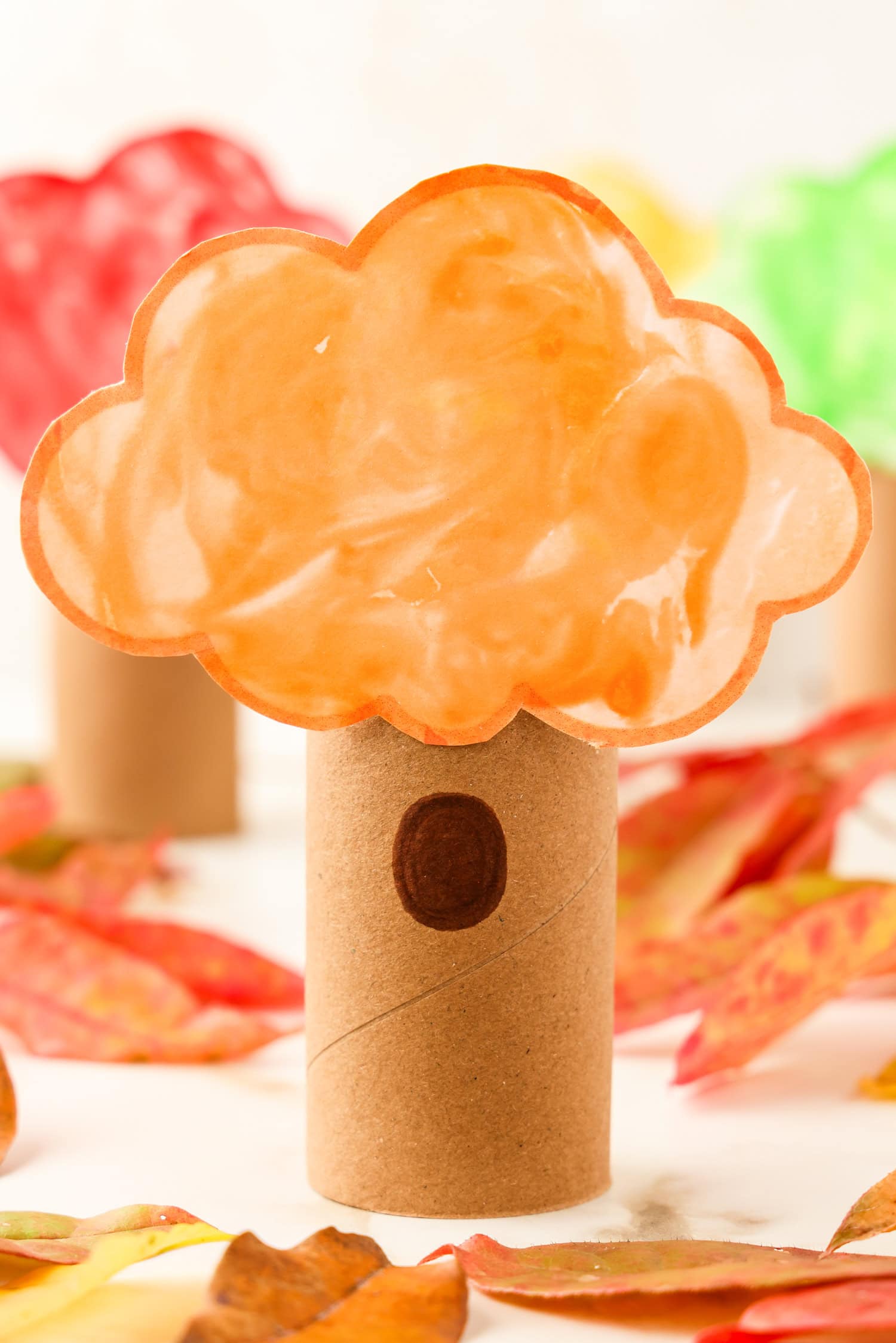 Adding a peep hole in the toilet paper roll with a brown marker for the Toilet Paper Roll Fall Tree Craft