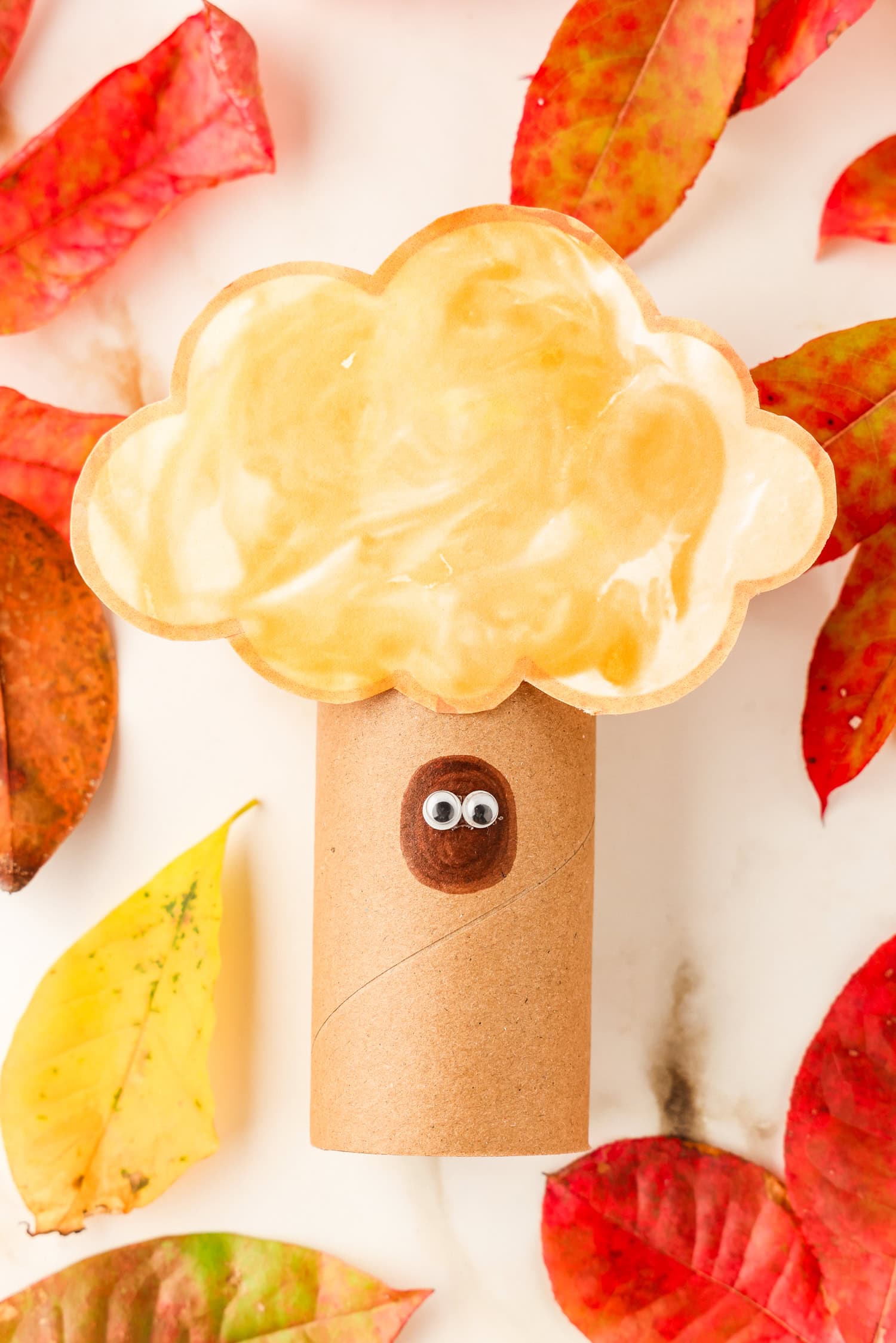 Adding optional googley eyes to the Toilet Paper Roll Fall Tree Craft