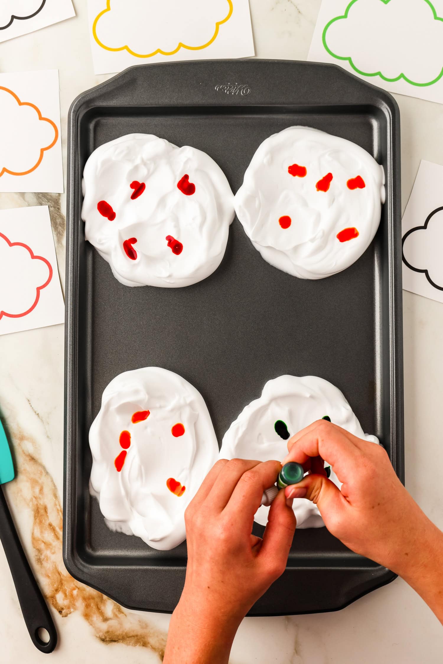 Dropping food coloring in clouds on sheet pan for Toilet Paper Roll Fall Tree Craft